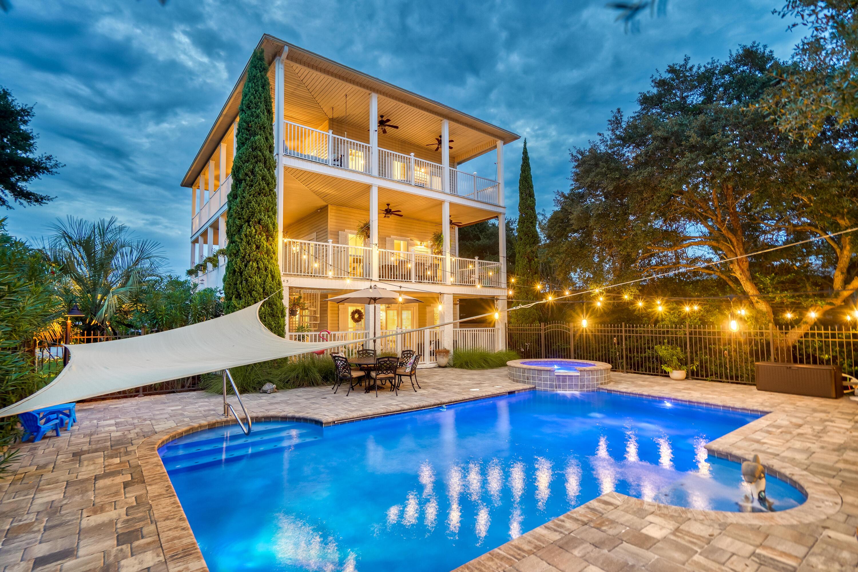 UNDER CONTRACT BUT TAKING BACK UP OFFERS. All decked out on the Emerald Coast is this hilltop Southern Charmer wrapped in 2100 square feet of deep covered porches designed to catch saltwater breezes and views of the emerald green waters of the Gulf. With over 1100 feet of gorgeous white sand private beach in the community  just a short stroll or quick golf cart ride away, the home is perfect as a rental or second home for two families or an extended family with grandparents along. Each floor of the three levels offers its own king-sized master bedroom and bath, washer and dryer hookup, kitchen or kitchenette with new Quartzite counters, and 700 square feet of covered deck.  The ground floor is a self-contained unit like an apartment and can be locked out separately from the top two floors, making it great as a separate space for grandparents who live in or visit.

The entire property is gated and twisted native oak trees provide a canopy of privacy for the pool and hot tub from the road.  
With the large private pool and spa, the property has as much outdoor living space as indoor, making your next reunion, BBQ, or wine tasting perfect for the whole family. Plenty of parking throughout the property and a covered carport with large storage closets are perfect for multiple families and beach toys. 

The first floor features one bedroom with full kitchen, full bath and even a laundry room. The second and third floors are connected inside by a spiral staircase to create a three bedroom retreat complete with kitchen, living area, kitchenette, two laundry areas, two master bedrooms and two master bathrooms with an extra queen bedroom on the top floor. Outside the second floor on the deck overlooking the pool is a custom made table seating 8, the perfect place for al fresco dining. The third floor with views of the Gulf of Mexico, Gulf Pines' Lake Morrison, Tops'l Resort and Sandestin Resorts is a quiet refuge with custom built swing bed perfectly positioned to catch the sunset or count the stars. All 3 floors have open wrap around verandas for your relaxation when you are not lounging on your private beach or in your private pool. Easy access to walk, bike or golf cart to the beach and spend the day soaking in the Florida sun and sand. Sold with most furniture remaining, this property is perfect as a second home or beach house for two families or a vacation rental offering 90k in projections. 

Newer systems include all 3 air conditioners and kitchen appliances. New aluminum railings, saltwater pool in 2019 including hot tub and pavers. Fresh paint, new Bahama shutters and LVP flooring on 3rd floor and new kitchen cabinets on 2nd/3rd floors.

Gulf Pines neighborhood is a hidden gem located south of Emerald Coast Parkway between the shopping, dining and entertainment of Sandestin and the excitement of Destin harbor. The community features over 1100 feet of pristine private beach, a neighborhood beach walkover and pavilion affectionately called "The Taj," two lakes and a voluntary HOA with dues of only $300 per year.  Come check out the joy and solitude of living off the beaten path in the Gulf side community of Gulf Pines. In this house, you can be ALL DECKED OUT in the best possible place to go.