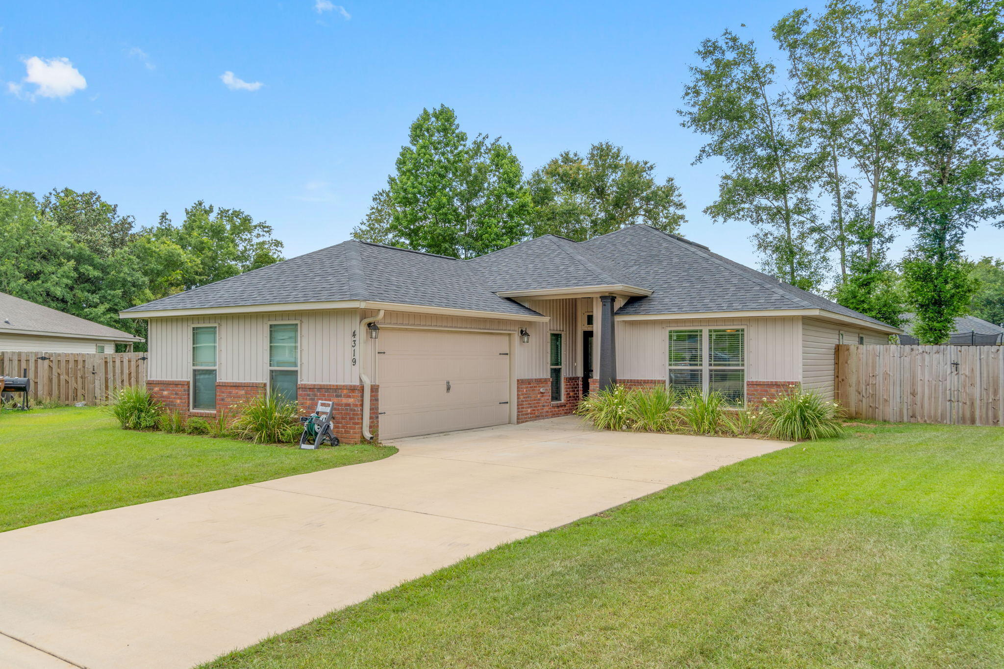 Welcome home to this fantastic 3 bedroom (plus a flex room/den!) home located on a cul-de-sac in the popular neighborhood of Woodlands centrally located in Pace and minutes from I-10, Hwy 90, NAS Whiting Field, UWF, Shopping and restaurants. Pull into the community and you're greeted by a beautiful winding road, with sidewalks, street lighting, underground utilities, and even a new neighborhood park and splash pad within walking distance! This home has great curb appeal with a courtyard entry, and it's on a fantastic large fully fenced lot. Inside you'll find high ceilings and luxury vinyl plank flooring throughout all the common areas and brand new (May 2022) carpet in the bedrooms! The spacious family room opens into the kitchen that has a hop up bar with pendant lighting, granite countertops with under mount sink, whirlpool Energy Saver stainless steel appliances with a flat top range, tiled backsplash, dishwasher, built-in microwave, garbage disposal, and a pantry with upgraded wood shelving. The master bedroom features a trey ceiling and the bathroom has a soaking garden tub, a walk in tiled shower, double vanities with granite counters, a private water closet, and a large walk in closet! The other two bedrooms are nice sized with ample closet space and a shared bathroom with the same granite counters and undermount sink. The bonus/flex room is a fantastic space accessed through a custom barn door and is currently used as a nursery. Enjoy a great sized laundry room with extra storage and shelving that leads to the two car garage, and outside you'll find a great sized fully fenced in backyard and a screened in patio to enjoy!