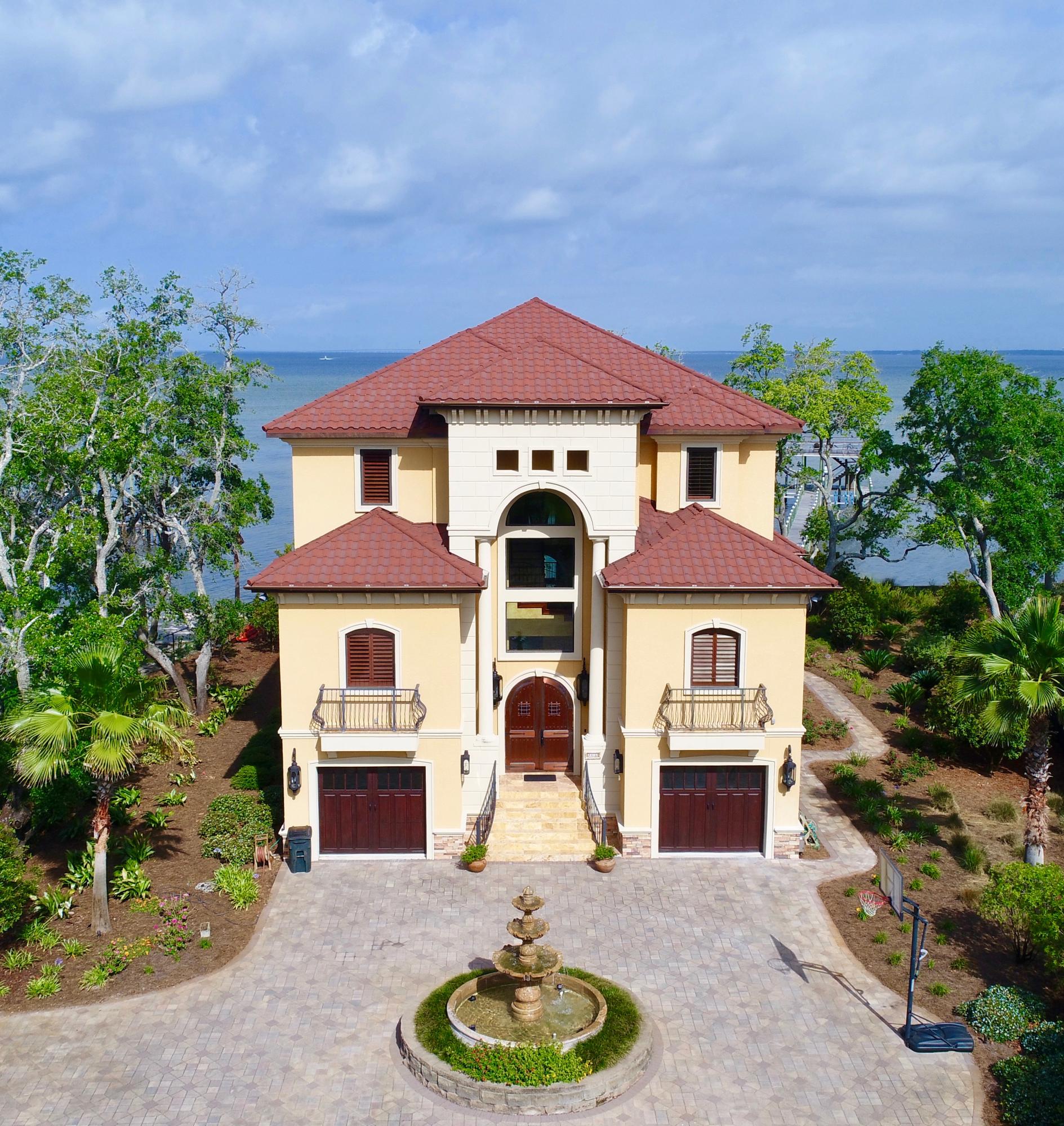 BREATHTAKING VIEWS! ONE OF A KIND WATER FRONT ESTATE! Tuscan Style home on extra large water front lot on the Choctawhatchee Bay. This home is built like a fortress. Commercial Construction. Red Iron, Light Gauge Steel and Concrete Construction. Energy efficient with closed cell foam through out, including walls, ceilings. Three inch reinforced concrete on floors/ceilings. 205 ft long dock
unibody construction with extra large pilings and cross bracing. Approx. 1500sqft of dock space. Boat lift for a 35 ft boat, 2 jet ski lifts, under decking, special design fish scaling sink and storage area. Screened salt water pool with hot tub. Large outdoor kitchen with granite countertops, cypress cabinets, Viking Grill Monogram 2 drawer dishwasher, icemaker, monogram GE refrigerator and GE Monogram warming drawer. Deep sink. Outside shower. Pool room with heat/ac with separate washer /dryer hookup.
Homes interior has travertine, marble and ceramic floors throughout. Mahagony stairwell treads. 2 fireplaces with granite hearths. Mahogany 11" baseboards and crown molding throughout. All baths have granite and stone countertops, 3 bidets , intensive tile molding in shower and tub areas of bathrooms. Large Gourmet Kitchen with extra large island with granite countertops. Kitchen with Viking Refrigerator, Gaggenau Steamer, Advantium GE Monogram Microwave, 2 GE Monogram refrigerator drawers, 2 Miele DW, GE Monogram Wine Cooler, Viking Gas 4 burner double oven with griddle.
Wine Cellar, CAT 5 wiring throughout house with smart lighting.
Media Room with raised seating including 9 theatre seat. State of the Art. 7.2 equipped, overhead 1080P Overhead Projector. Optimized sound in walls.
Top of the line bath fixtures, light fixtures, ceiling fans throughout house.
Custom plantation shutters, electric blinds. Built in cabinetry in living room, dining room, library.
Private upstairs Master Suite located on third floor with private lanai, fireplace in library, office and large glamour bath. Large walk around shower with multiple shower heads.Tub with air bubble jets. Double vessel sinks with separate vanity area.
Living room with 5.1 video/sound system. Lanai wired for speakers. Lower lanai by pool has speakers.
Professionally landscape, plan by Pensacola Landscape Architect. 
Whole House Generator, Elevator, 3 Rinnai tankless water heaters, private gated entrance. Italian Granite Fountain. 
Enjoy relaxing on any of the three lanais. On any given day, watch dolphins, ducks, pelicans and even bald eagles. If you like to fish, you will be in heaven. Deers have even been spotted on early mornings and late evenings. 
This is home is truly a one of a kind.
So many more extras. It's a must see, if you are looking for a unique water front home, no need to look any further.
Construction photos available if requested.