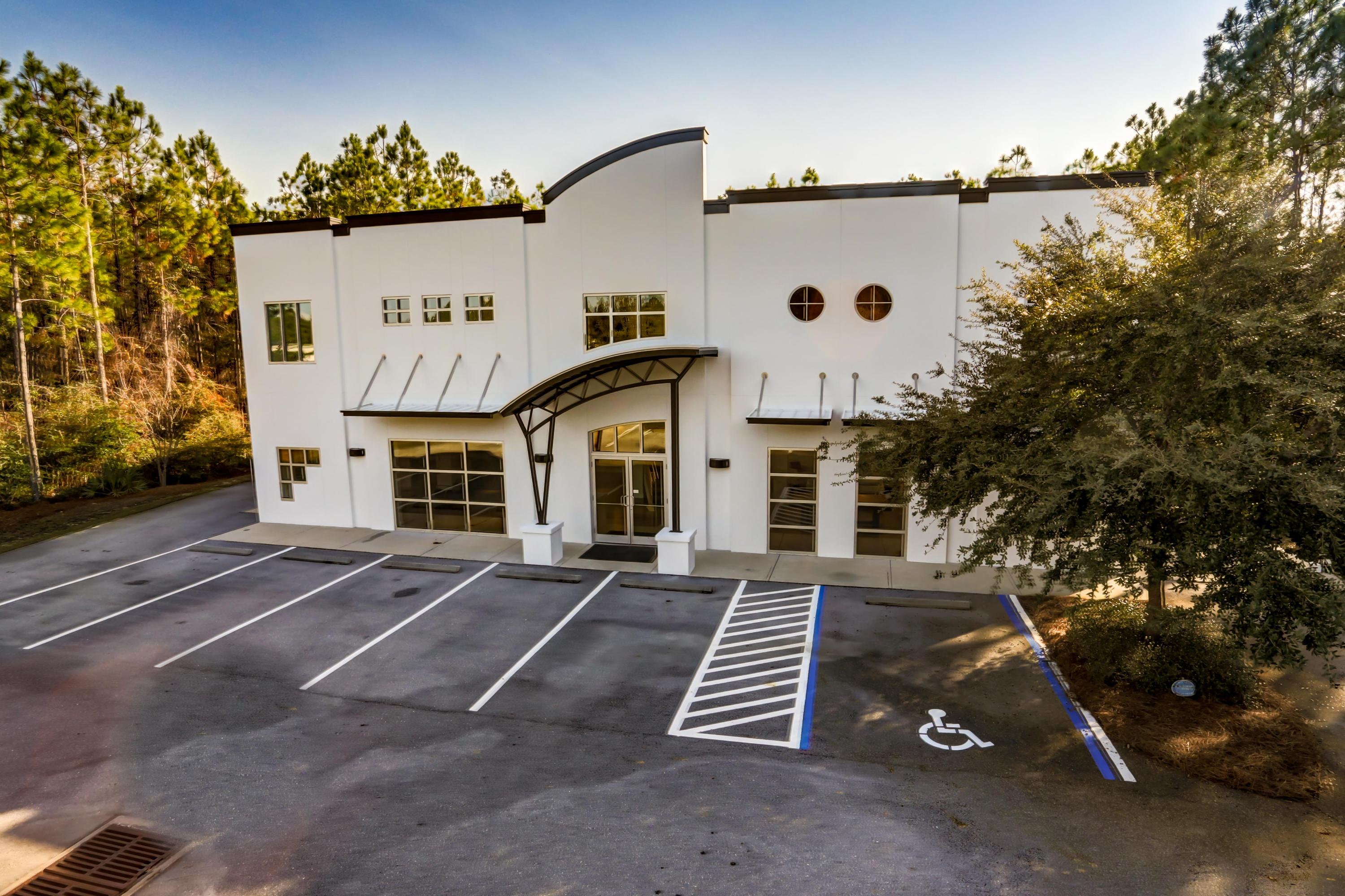 Exceptional +/-10,000 SF Showroom, Office, Warehouse, and Flex space situated on approximately .71 acres in St. Joe's South Walton Commerce Park and located in the South Walton County market of Northwest Florida. This premier site is well positioned logistically to Okaloosa, Walton, and Bay Counties, serviced by Interstate 10, approximately 25 miles to the Northwest Florida Beaches International Airport (ECP), 27 miles to Destin, and 74 miles to Pensacola.
Containing a poured cell block exterior with a reinforced metal building and fortified roof system, the structural nature of this improvement is quite impressive. While the exterior projects modernized architectural elements, the interior finishes are commensurate and consistent throughout... The interior consists of two floors, each measuring approximately 2,500 SF. The first floor accommodates a gorgeous showroom space. The second floor, which is accessed by either a magnificently designed staircase or a large stainless elevator, contains 7 executive offices.  A beautifully designed kitchen, bathroom, lounge area, and conference room services the Class A office suites.  The mezzanine level also offers a spiral staircase to the approximate 5,000 SF of climate-controlled, open warehouse space with a receiving office and two 12'x12' roll-up doors, one of which is located at the covered loading dock.  

This site will cater most effectively to St. Joe's 50-year growth plan, known as the Bay-Walton Sector Plan.  The uploaded property survey illustrates 13 parking spaces.  The floorplan is uploaded as well.  Buyer must verify all information and specifications.