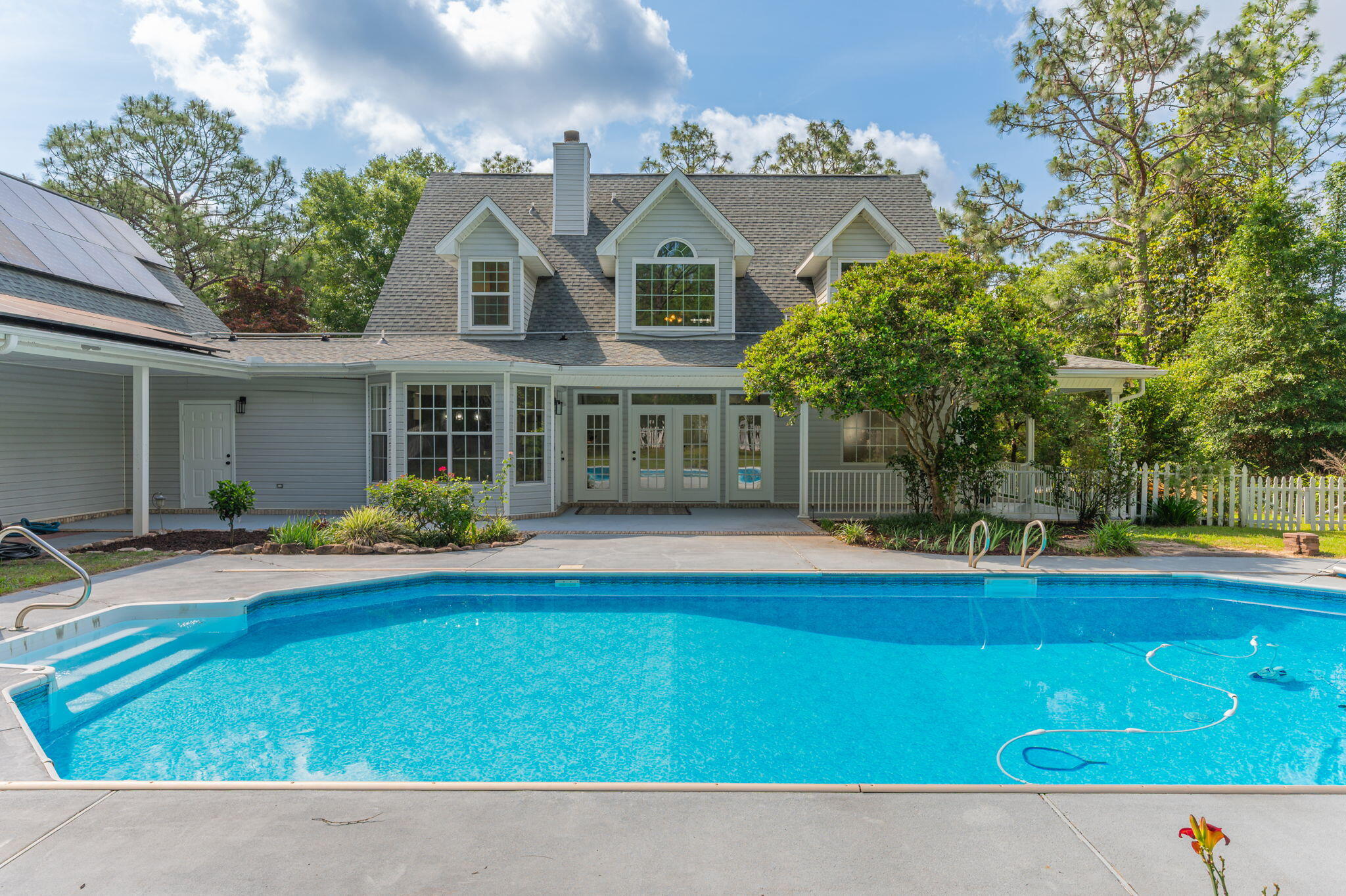 This beautifully, updated custom-built  2 story pool home boasts an expansive 4.83 acres lot in the heart of Crestview offering both privacy and ample space for outdoor activities. With 4  bedrooms and 4.5 bathrooms, This well maintained home combines luxury with comfort. As you enter, you'll be greeted by the elegance of professionally painted interiors that complement the flow of the new LVP flooring throughout the main living areas. The kitchen boasts brand-new appliances, quartz counter tops with plenty of counter space and storage. Master Bedroom is on the main floor. Upstairs bedrooms have brand new carpet.Brand new roof and paid off solar panels, loft style apartment opportunity over the 3rd garage with possible income opportunity