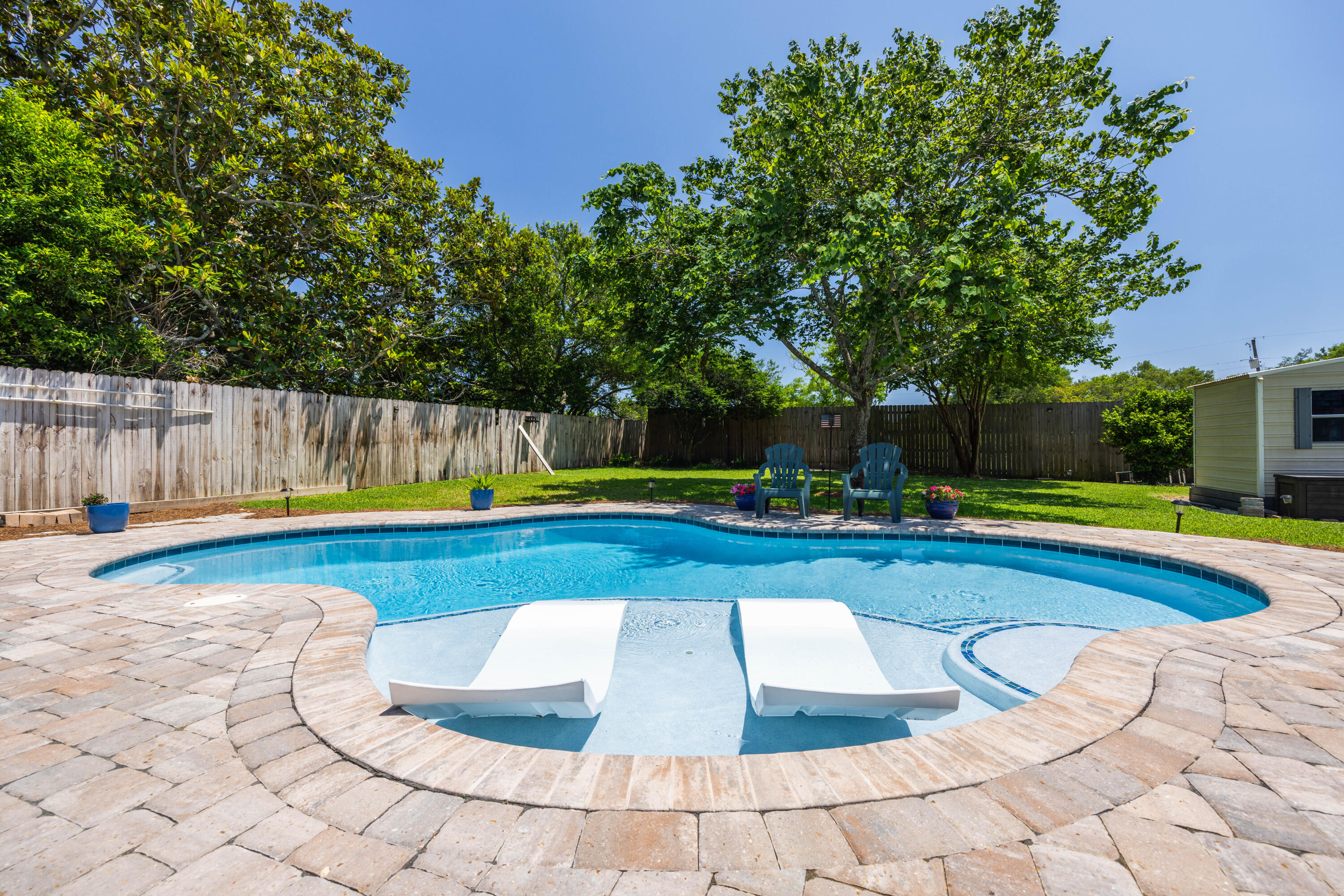 Welcome to your slice of paradise in Destin, Florida! Nestled on a generous .25-acre lot, this charming home offers the perfect blend of comfort and style. Step inside to discover a beautifully renovated interior featuring three bedrooms, two baths, and not one, but two spacious living areas, providing ample room for relaxation and entertainment.

The heart of this home is its stunning custom salt water pool, complete with in-pool tanning ledge loungers and LED lights, creating a resort-like oasis right in your backyard. Imagine spending sunny days lounging by the pool, soaking up the Florida sunshine, or enjoying evening swims under the stars.

For those who love to entertain, the outdoor space is a dream come true. The pool area is accompanied by a custom-built composite deck, providing the ideal spot for al fresco dining or simply unwinding with a glass of wine. The expansive backyard offers plenty of space for outdoor activities, making it perfect for family gatherings or hosting friends.

Conveniently located in Destin, known for its beautiful beaches and vibrant community, this home is just minutes away from shopping, dining, and all the attractions that make this area so desirable. Don't miss your chance to own this fabulous home - schedule your showing today and start living the Florida lifestyle you've always dreamed of!