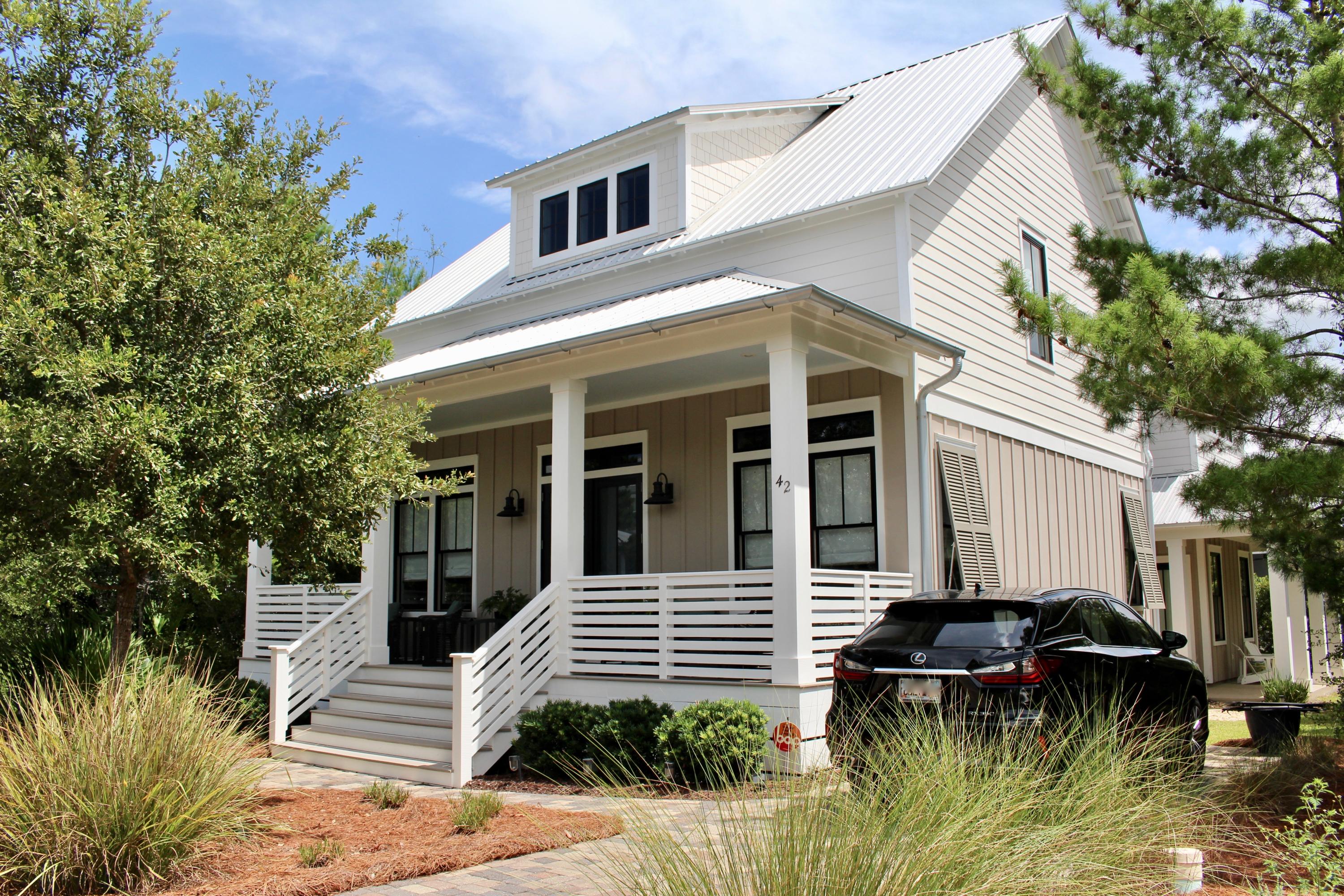 One of the few homes in The Preserve at Grayton Beach that has a main house (1630 sq ft) and separate guest cottage (780 sq ft) has never been rented (sq ft is approximate , both totaling just under 2400 sq ft). Greeted by beautiful custom stair rails with glass and cathedral wood ceilings, solid hardwood flooring throughout with exceptions to tile in the bathrooms. Main house has 3 bedrooms and 3 1/2 baths. With a master bedroom on the first floor and 2 guest bedrooms with full baths on the second floor. The kitchen boasts of custom cabinets with under cabinet lighting, pantry, stainless steel appliances, tiled backsplash and marble countertops with barhop. A full size stackable washer / dryer and 1/2 bath also on the first floor. The master bath has a tiled surround walk-in shower, double vanity with marble countertops and porcelain tiled flooring. There is an under-the-stair storage closet for storage.  Both guest bedrooms on the second floor have their own bathroom.  Both bathrooms have tiled flooring, tiled surround shower and granite countertop vanities.  The guest cottage on the first floor has a kitchen with refrigerator and convection microwave, living area, 1/2 bath, stackable washer/dryer and under the stair storage. The second floor has a bedroom and full bath with large walk-in shower.  Granite counter tops in the kitchen and bathrooms vanities.  Hardwood flooring on the first floor, tiled bathrooms and carpet in the bedroom.   Homes have been very well maintained inside and outside.  Beautifully landscaped with sprinkler system, brick paved walkway to the cottage on the north side of the home and steppingstones out the back door to the cottage.  The cottage was built in 2012 and the main home in 2014.  Homes are being sold unfurnished with exceptions to the beds (headboards, frame, mattress, boxsprings) tv's and dinning table with 6 chairs.  There is a storage area under the house for beach items.  The Preserve at Grayton Beach has a deeded beach access, gated community, 2 swimming pools (1 that is heated) 2 tennis courts, community room, exercise room and backed by Grayton State Park.