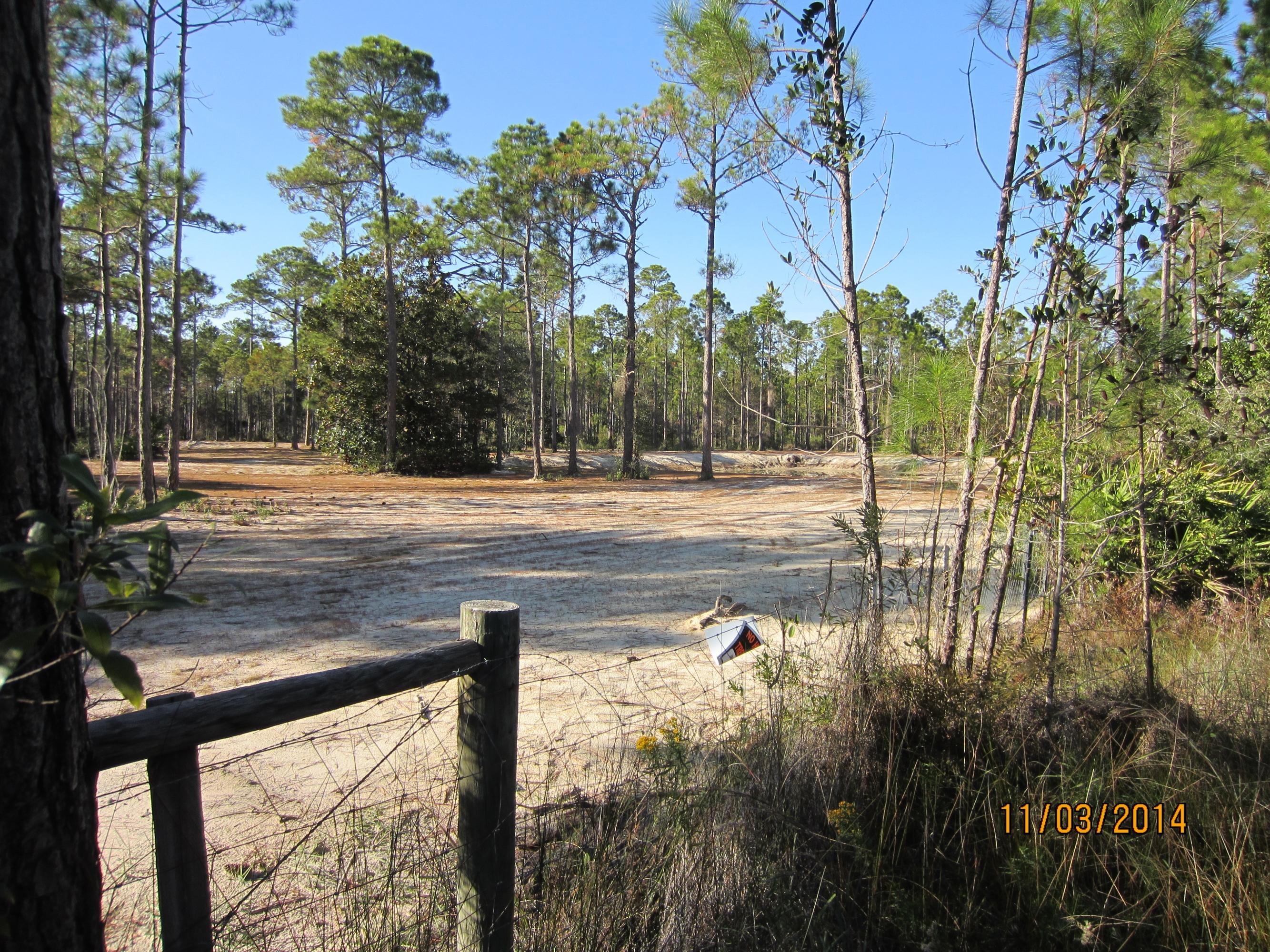 REDUCED REDUCED. 14 acres of attractive vacant land with the underbrush removed. There are four individual parcels of record. There are three small ponds on property and most of the acreage is fenced. Easy to drive around on the property. Access is secured with a cattle gate at the entrance. Excellent property for horses, or as a country estate. Property is very private. Public water and sewer available. The ponds are approximately six feet deep. Approval has been obtained from DEP/COE for access off North Church Street and Wetlands have been marked. Beautiful land and perfect for horses and that country estate. Walton County zoning one unit for each 2.5 acres. Private but close to everything.