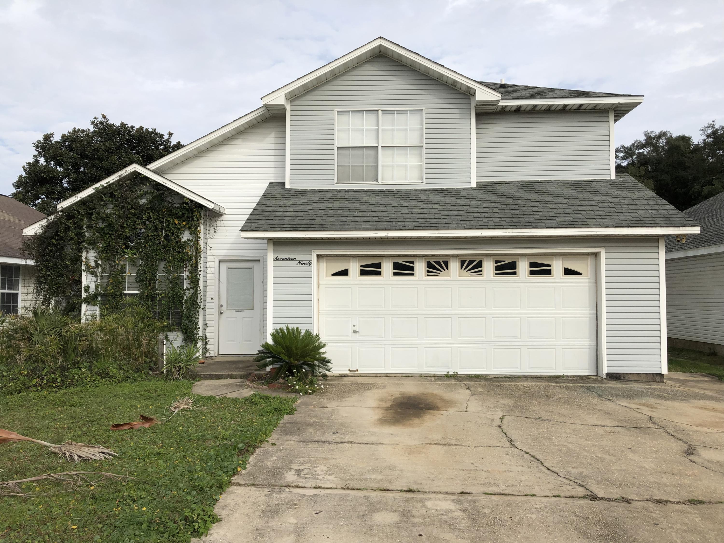 Two Story, 4 Bed/2.5 Bath Home located less than 1/4 Mile from Santa Rosa Sound Water Access in the Charming and Desirable Neighborhood of Ivalea Gardens. First Floor has 18 x 18 Ceramic tile throughout, Spacious Kitchen with Stainless Steel Appliances, Travertine Tiled Counters, Tiled Backsplash, plenty of cabinetry and accent lighting, along with a bedroom that would also be great for an office, a half bath, and a large dining area. Additionally, the main floor comes with vaulted ceilings and extra storage under the stairwell. Second Floor has the Master and two additional bedrooms and 2 full baths, as well as a large Bonus Storage area at the top of the stairs. Both bathrooms have Travertine counters, with Dual Vanities in the Master, and a sizable Master Closet. The two car garage has storage and shelving and a opens to a large driveway for plenty of parking.  The home has vinyl siding for easy maintenance and a privacy fence.  Close to shopping and other attractions--Located approximately 12 miles from Hurlburt Field/Ft Walton Area, just down the road from Santa Rosa Sound Access where you can fish, Kayak, and catch fantastic Sunsets and Sunrises or gaze at the stars, and is just minutes from Navarre Beach's Emerald Green Waters and White Sandy Beaches. Additionally, shopping & restaurants are nearby, with a recently new Neighborhood Walmart just across HWY 98.  Home is being sold in "AS IS" condition.  *Home may need extensive work.*