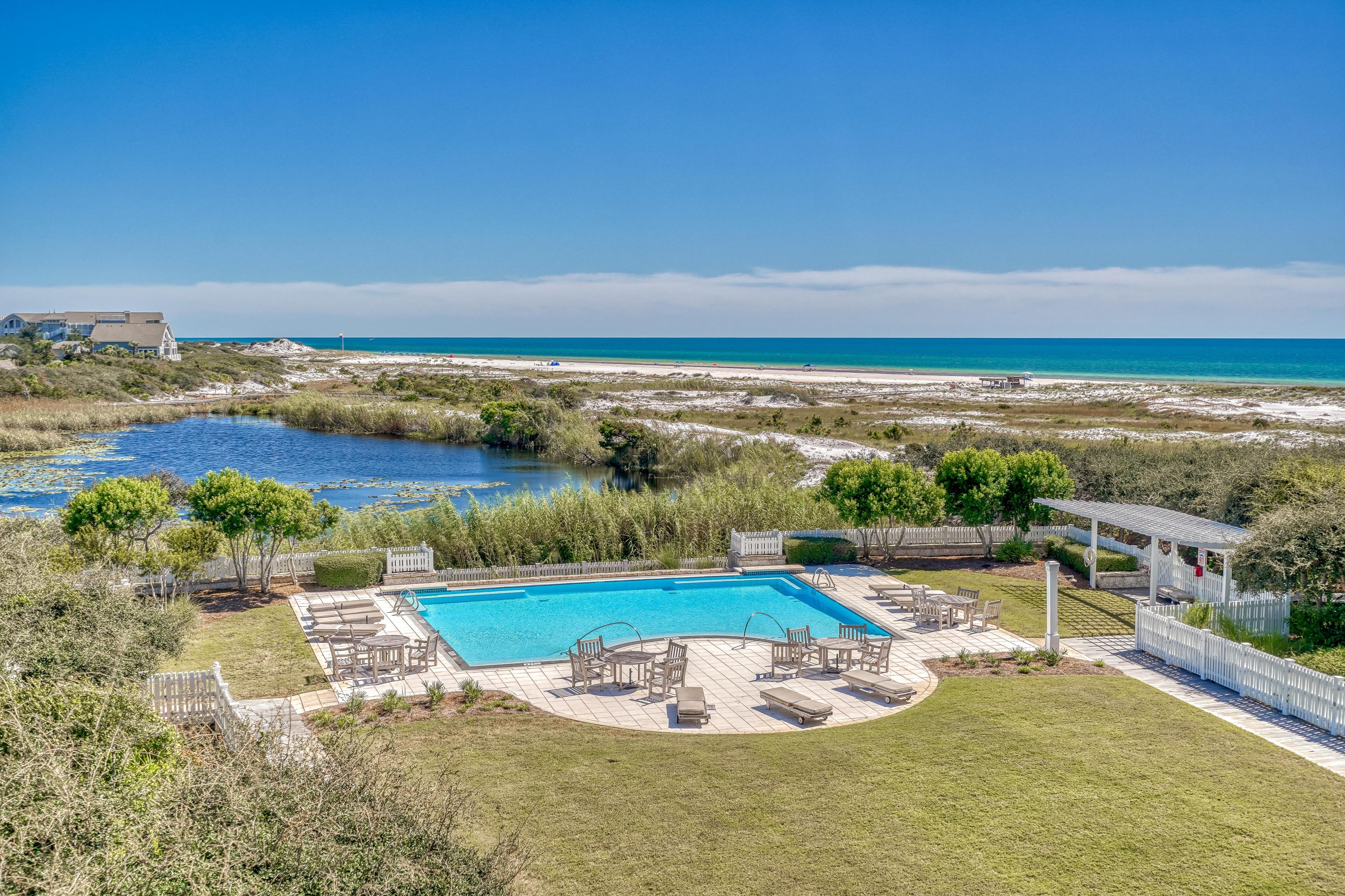 Enchanting gulf and lake views characterize this impeccably renovated gulf front 3BR/3.5BA residence in Compass Point II in the WaterSound Beach community. A welcoming open concept design makes entertaining effortless while each bedroom offers an ensuite bathroom for added privacy. From the moment you enter,  notice custom upgrades throughout including new oak hardwood floors, designer lighting, updated bathrooms, and designer furnishings. A calming color palette and design details such as board and batten in the living and dining area and luxury wallpaper creates sophisticated coastal retreat.The kitchen has been fully upgraded with a new larger breakfast bar, floor to ceiling cabinets and a white geometric backsplash.  Viking appliances include a wine refrigerator. Directly off the living area find a newly tiled expansive balcony with sweeping views of the gulf, lake and pool. The master bedroom is a true sanctuary with stunning views, custom his and her closets and a gorgeous master bath with dual vanities, new cabinetry, soaker tub and large walk-in shower. The master suite and a guest room offer direct access to balcony while a morning bar w/wine cooler, ice maker, coffeemaker and shelving provides added convenience between the two guest suites. Owners enjoy a beautiful pool, boardwalks to the beach and a single car garage. This residence is furnished with some exceptions. 
Both sophisticated and stylish, the gated WaterSound Beach community located south of Scenic Highway 30A offers homeowners a rare sense of seclusion with easy access to area activities. Amenities include swimming pools, a puttering park, community green spaces, a state-of-the-art fitness center and private boardwalks to one of the most beautiful mile stretches of coastline in the area.