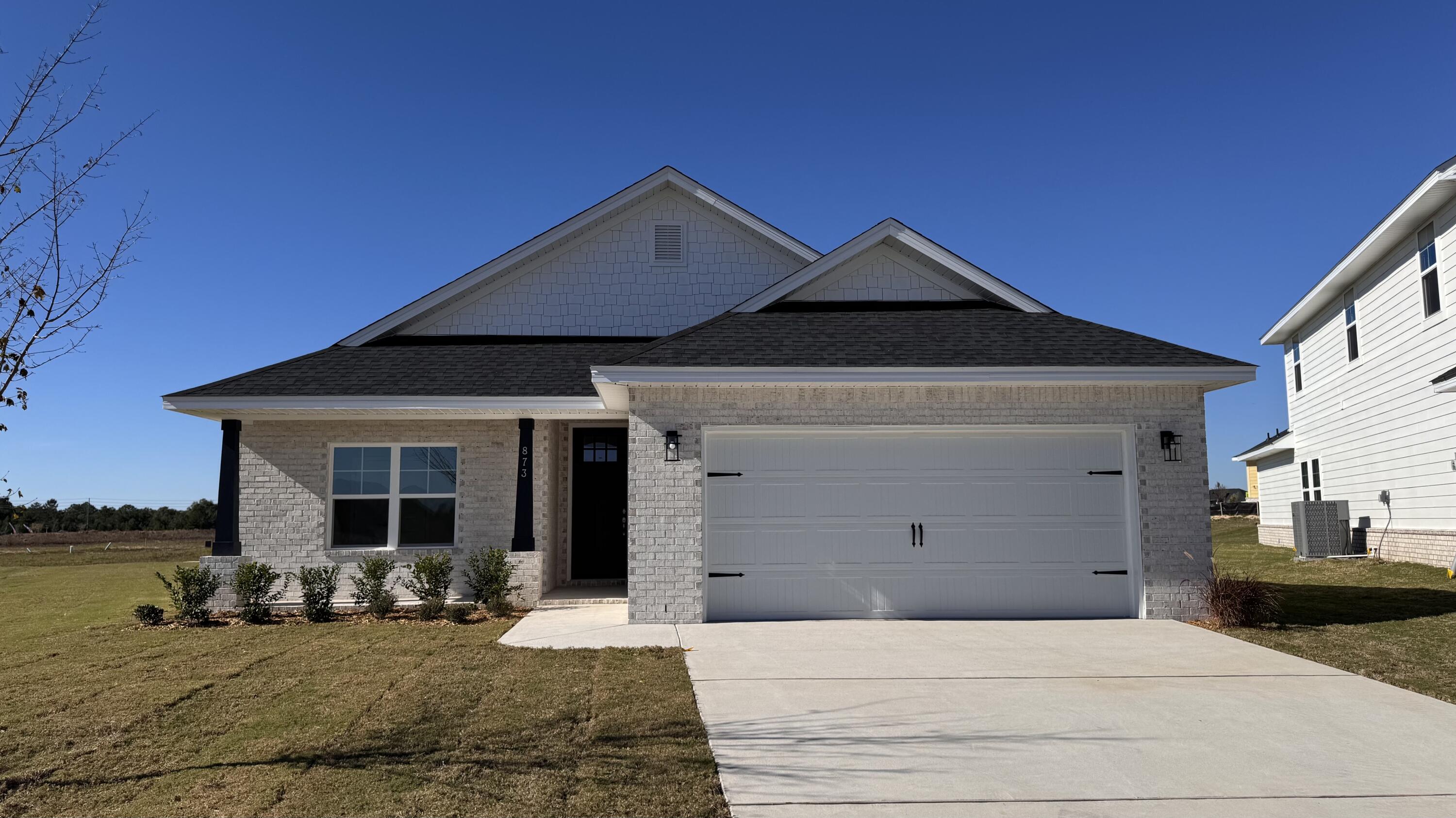 Builder pays most closing costs when buyer chooses a preferred lender, plus  up to $25K in flex money is available.  Use it towards any combo of a rate buydown, remaining closing costs, prepaids, HOA fees or builder options such as a screen enclosure or fridge, etc. 20 minutes from Blue Mountain Beach!  F Full brick, open concept, 3 bedroom, 2 bath plan with LVP flooring throughout; no carpet. Home features minimum 9' ceiling height with trey in M. Bedroom and soaring ceiling in living room.  8' entry doors, large rear covered patio, Master bedroom is 14 x 22.  Generous size master closet, separate garden tub and shower, quartz counter tops, undermount sinks, lever-handled doors, sprinkler system with well & pump, fully sodded yard, pull-down attic stairs, garage opener.  Sit