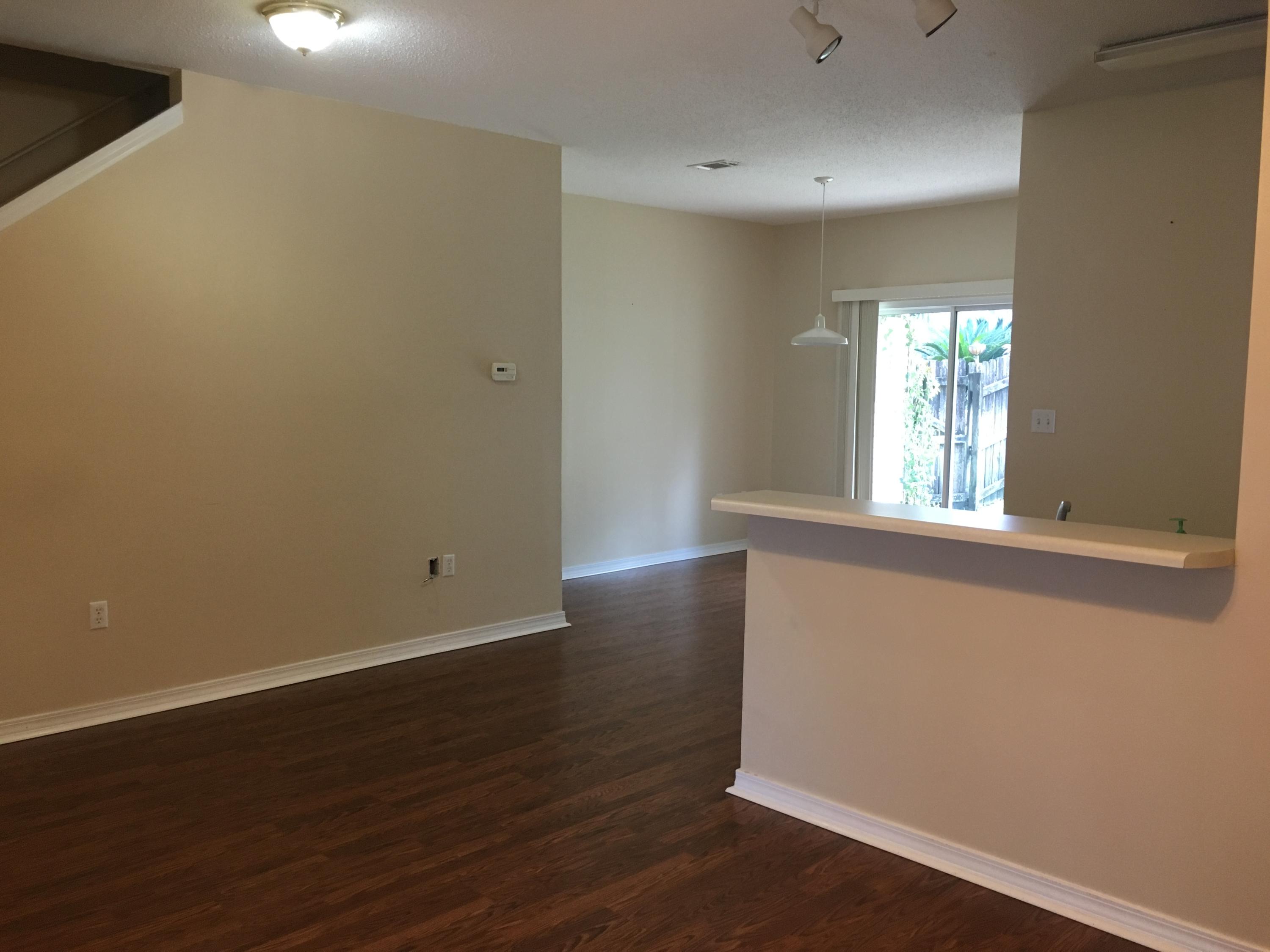 Well maintained townhome right in the heart of Destin in the Magnolia Park neighborhood. The downstairs has hardwood floors in the family room and dining area. Tile in the kitchen and bathrooms. Half bath and laundry downstairs. The glass sliding doors open to a private patio and fenced back yard. Carpeted bedrooms upstairs are good size and each has their own bathroom and walk-in closet. This home also has a 1 car garage