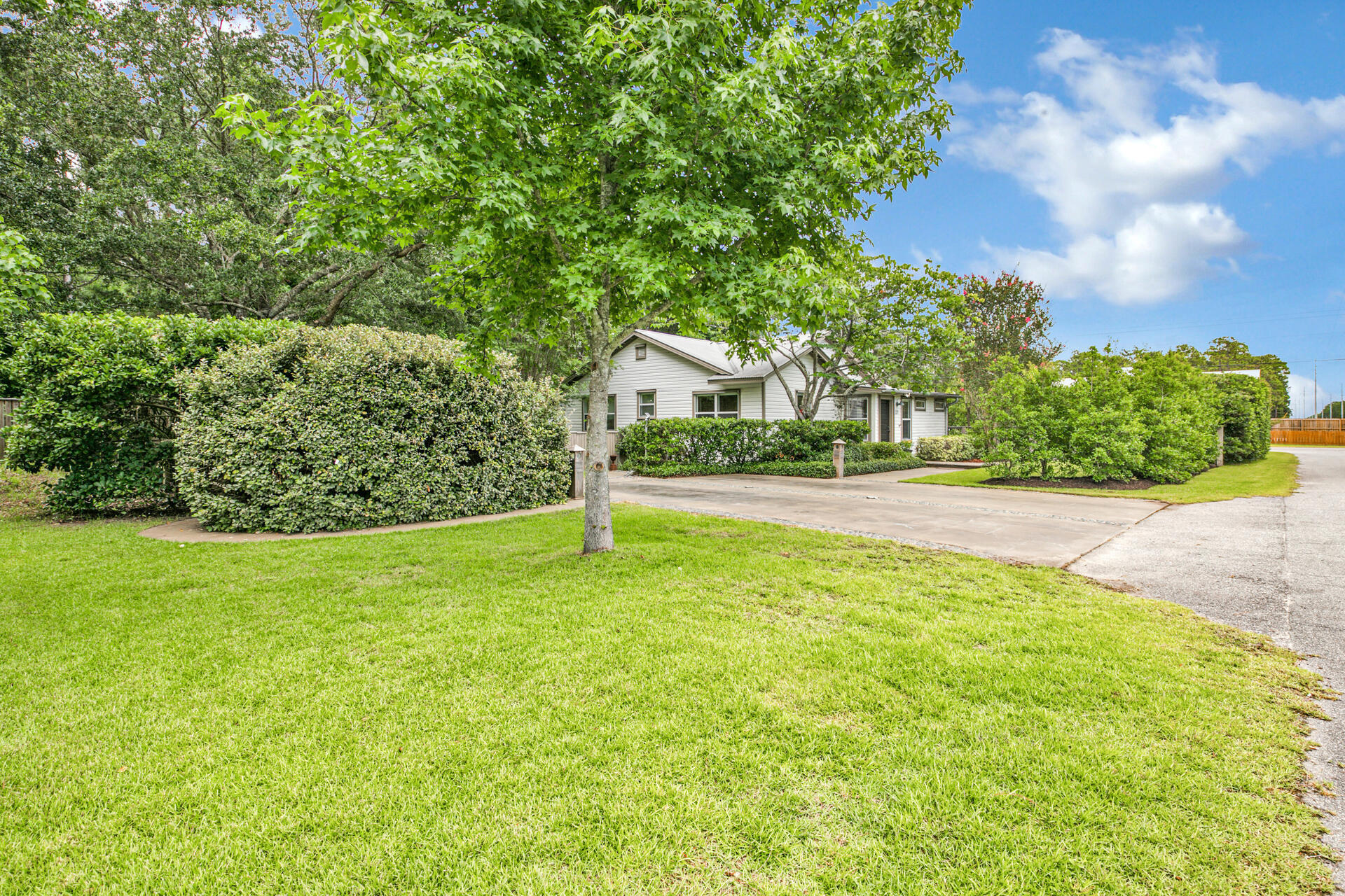 This newly updated cottage is full of sunlight and beautiful views of the outdoors. Original oak floors, solid wood doors and unique hardware add to its historical charm. The open floor plan centers around a large island with a stunning cypress top. The living area has a built-in bookcase and french doors leading to an expansive deck. Entertaining is easy with the custom outdoor grill. Cooking is a joy in the kitchen that features stainless appliances, terrazzo countertops and a walk in pantry with loads of storage. The primary bedroom has a walk-in closet with built-in shelves. The master bathroom has one-of-a-kind concrete sink, counter and flooring.  Full guest bath recently added to increase functionality. New energy efficient upgrades include a Trane HVAC, Low-E interior storm
windows, fiberglass entry door, spray foam insulation in the attic and a nest
thermostat. Outside you'll find a garden shed for your tools and beach gear along
with a larger workshop/mancave. Your fur babies will love the fenced yard with
doggie door and kennel. A garage/storage building with plans was recently
approved, making this location ideal for a small business owner wanting easy
access to South Walton.

Newly constructed bathroom with claw foot tub/shower combo.