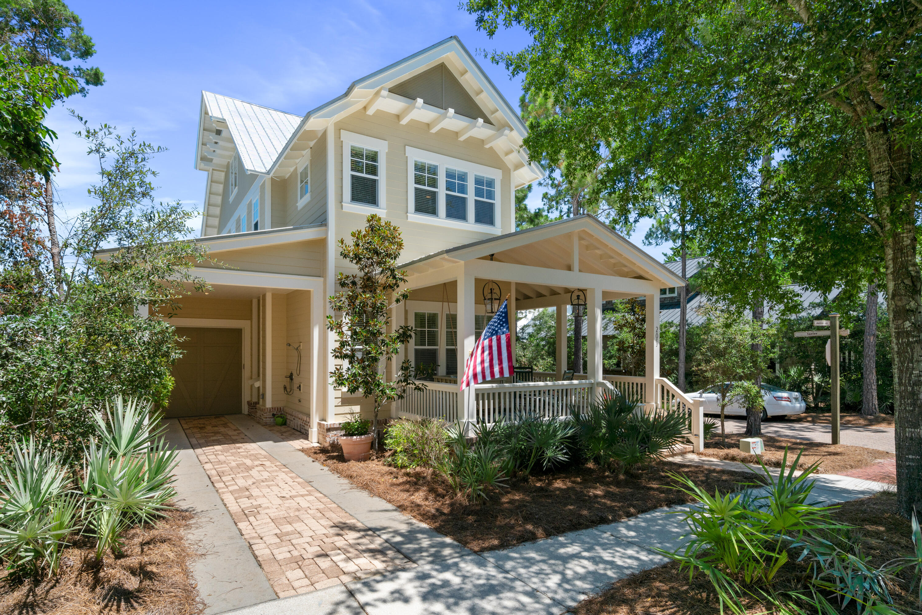 Welcome to southern cottage life with a coastal vibe.  This home built by Luke & Blues is located on a prime corner in Forest Lakes and has many windows allowing for lots of natural light and brightness. Being sold by the original owner and is a primary residence and has never been rented.  The mature trees and brick paver streets of the neighborhood encourage you to wander the community and to enjoy the pool, green space and playground areas.  Also, an easy walk to the closest public beach access.  This 4 Bedroom, 3.5 Bath home feels much larger than its total square footage because of the open floor plan and light neutral colors.  The entire home has natural pine plank floors with the exception of tile in the bathrooms. An extra large island in the kitchen is the perfect spot for extra seating, food prep and even a buffet.  The pantry is adjacent to the kitchen and has space for food storage as well as small appliances.  The attached garage is large enough for a golf cart, bikes and even beach chairs and toys.  A jack & jill bathroom connected to two bedrooms upstairs makes this space unique and functional.  A perfect spot to relax is on the front porch swing under the glow of the gas lights.