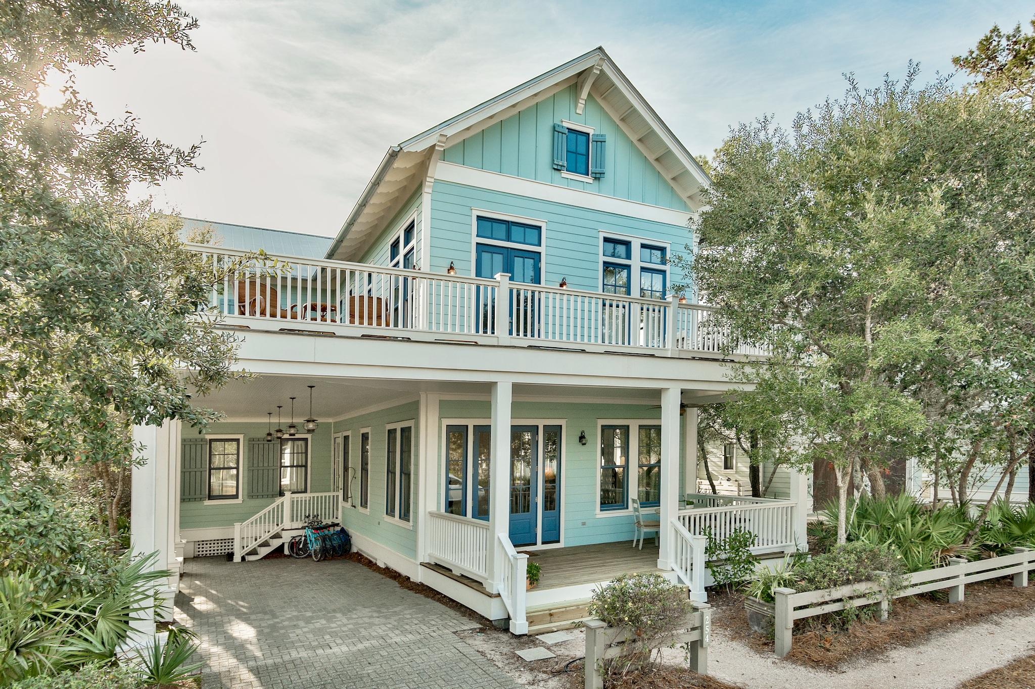 Custom home with rental revenue over $140,000/yr! This luxury home is being sold furnished, with 5 bikes, and all the outdoor furniture needed for over 2,000 sq. ft in porches! Combined with 3 fireplaces, there is ample space for both indoor and outdoor gatherings. The lot is adjacent to a 10' buffered bike path adding extra space between homes. Spacious, open living with ample room for family and friends. New paint and outdoor decks freshly stained. The master bedroom features a beamed coffered ceiling, cottage wainscoting, custom maple closets as well as a bath that features an Ultra Bain Air Jacuzzi tub, and double shower heads in the spa-like shower with split-face European stone. Each guest bath features tumbled marble tile floors and intricate mosaic marble tile showers, as well as custom hand rubbed antique finish cabinets and Fleur de Lis high-end reproduction plumbing fixtures. Kitchen features include granite countertops and 2 sinks. The kitchen island adds extra room in addition to the large round dining table and built-in breakfast nook.  For either a 2nd home or investment property, this home checks all the boxes.