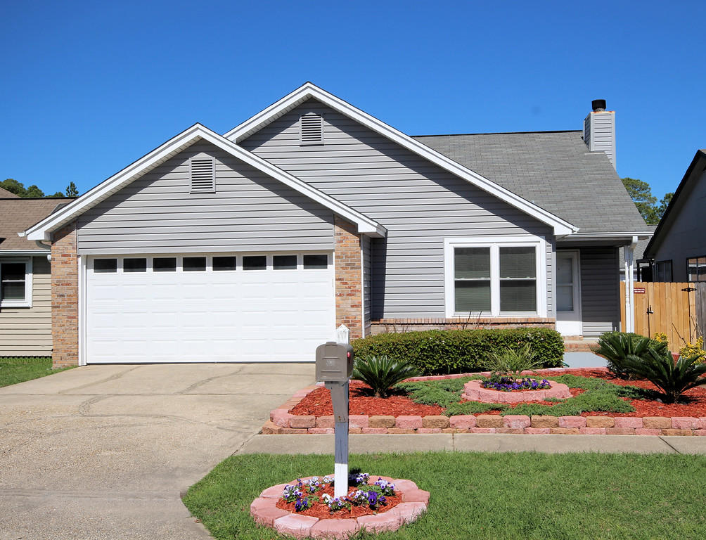 This well kept house is within minutes of Hurlburt Field AFB and white sand beaches! Nice sized three bedrooms, two baths and two car garage. Spacious living room with cozy fireplace. Airy kitchen and dinning combo. Stainless Refrigerator. Large deck that is accessible from the master bedroom and living room area. Lush landscaping with lots of flowers and fruit trees. It's a great curb appeal! New fenced yard for your privacy. One year home warranty provided. New A/C unit this year.