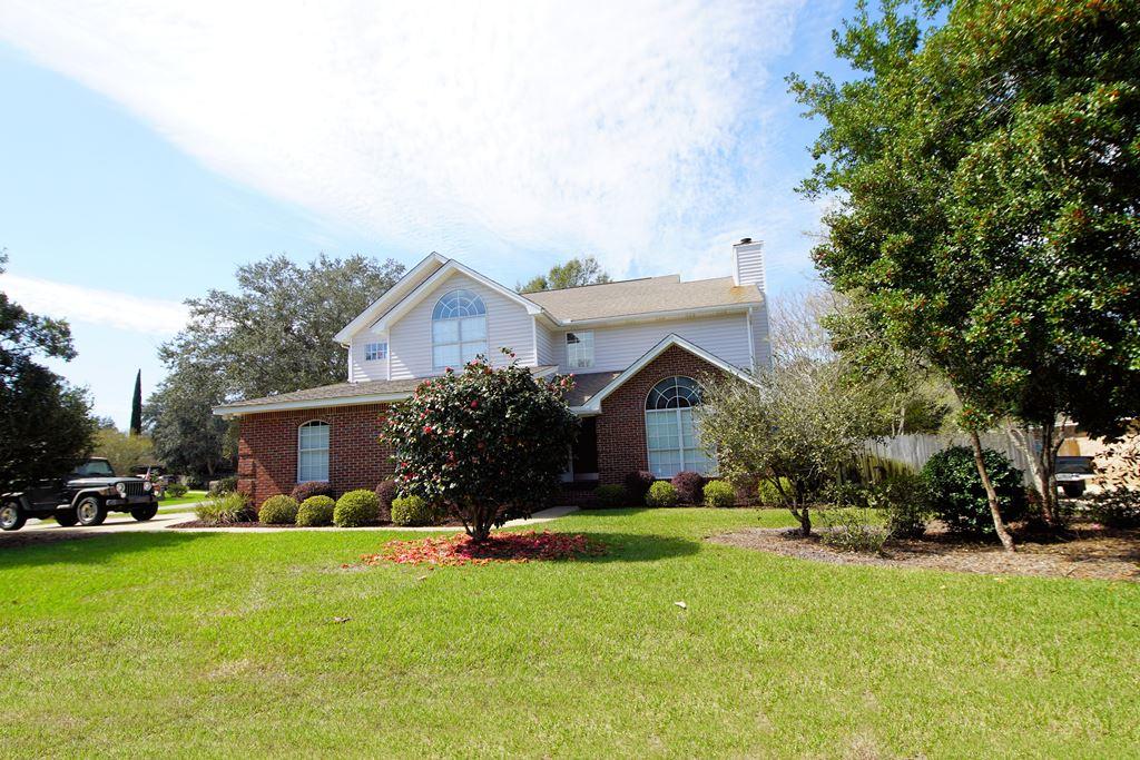 Beautifully updated home with multiple living areas on a large corner lot in Parkwood Estates of Bluewater Bay. When you enter this home, you will be drawn to the 23' ceilings in the living and dining room that is flooded with natural light streaming in from the oversized windows. Adjacent to the dining room is the renovated kitchen featuring an abundance of granite counters and plenty of cabinets. The kitchen is open to the cozy breakfast nook and family room with French doors leading out to the paver patio area and large back yard. On the other side of the family room you will find a downstairs bedroom suite with a full bath, the perfect place for guests or a home office. Upstairs is the oversized master suite with a luxuriously updated master bath as well as two additional good sized bedrooms that share the 3rd bath. The backyard is GREAT for evening bar-b-q's on the paver patio area while the kids play on the wonderful swing set. This home is located on a corner lot as well as in a cul-de-sac so there is virtually NO traffic on this quiet street. In 2010, this home was updated with hardwood floors throughout the downstairs, lighting, granite, stainless appliances and plumbing fixtures. According to the previous owners, the roof was replaced in 2006 and the HVAC was replaced in 2008. You will want to put this home FIRST on your list before it is SOLD!
