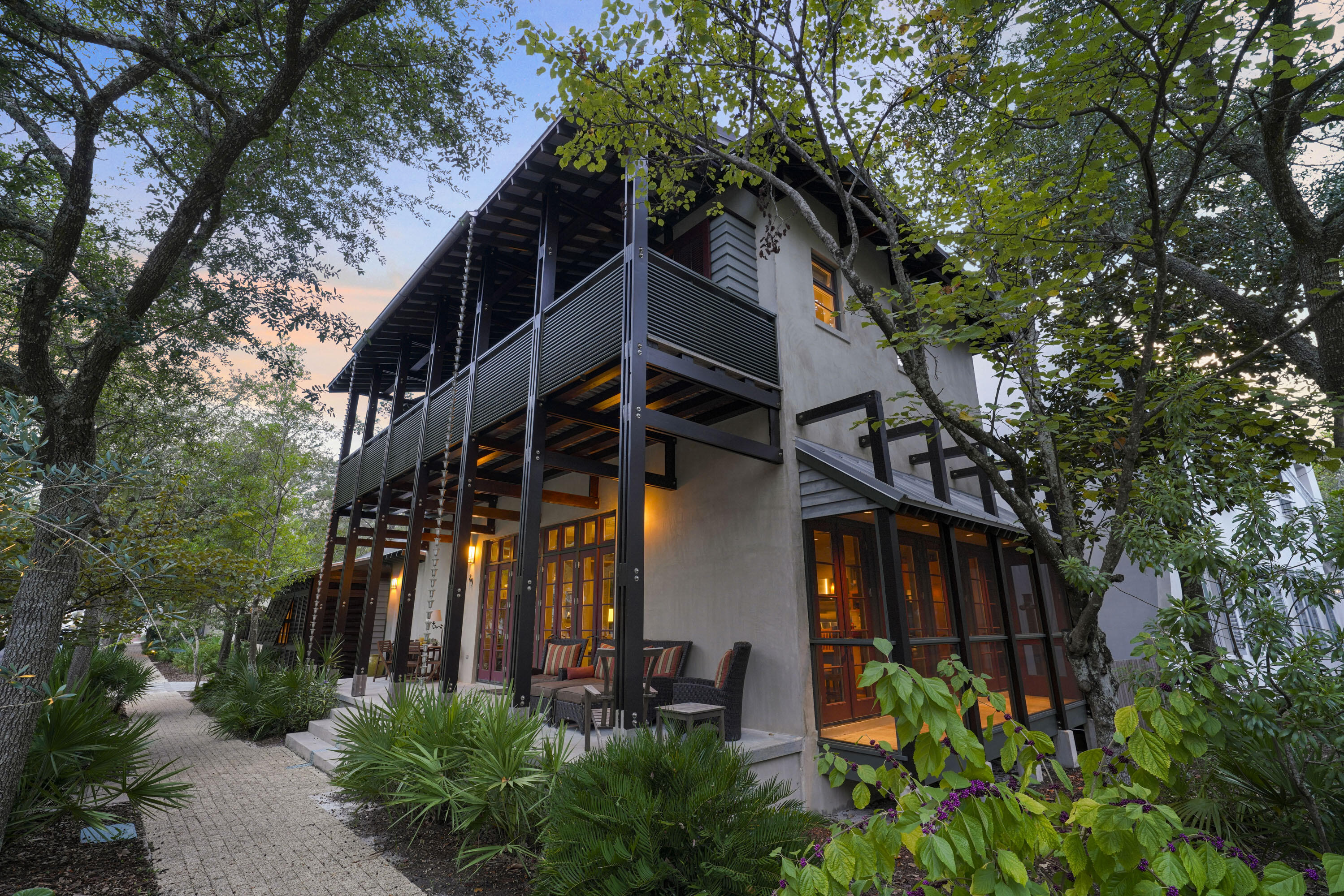 This one-of-a-kind home in Rosemary Beach was designed by Jonathan Lawrence and Bret Azzarelli of Elements Architects in Tampa. Sitting beautifully between Tuckers Lane and West Water Street, it offers over 80 feet of frontage on Georgetown Avenue. With an open floor plan, it's perfect for entertaining family and friends.

The owner's suite is a private bungalow with Australian Cypress floors, two walk-in closets, and a bathroom featuring dual vanities and a granite-topped shower. The bungalow can also be locked off for exclusive use. 

The main house's first floor boasts Black Terrazzo and Australian Cypress flooring, along with mahogany doors. The living, dining, and kitchen areas flow together, making it great for gatherings. The kitchen features granite countertops, a Wolf 6-burner stove, Bosch dishwasher, wine cooler, and a large island with seating for three. The dining space has a table for 10, and the living area includes a cozy gas-assist wood-burning fireplace and a charming library nook.

Upstairs, you'll find three bedrooms, two full baths, and a half bath, all opening to a spacious porch with views of Georgetown Avenue. A laundry area is also conveniently located on this level.

The third floor houses a media area with a wet bar, bonus room, and a half bath, along with another gas-assist wood-burning fireplace.

Outside, enjoy the enclosed courtyard with seating and an outdoor shower. The garage and parking pad accommodate two cars, with additional street parking available. Built with stucco over concrete block, IPE siding, and cedar trim, this home is both durable and stylish.

The home is sold furnished. Don't miss the chance to see this truly unique home.