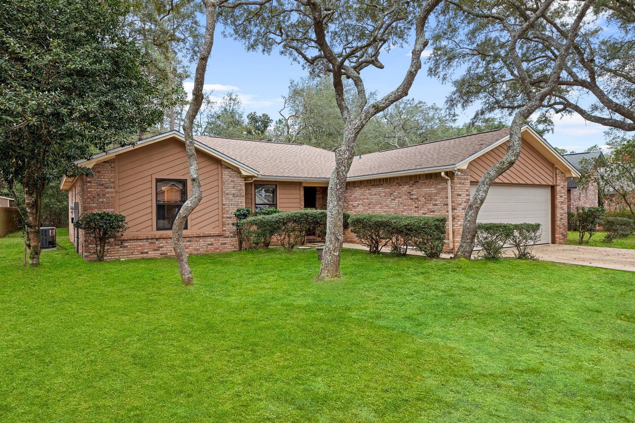 Introducing this charming brick home nestled on a wooded lot in the desirable Woodlands community of Niceville, FL. This inviting residence boasts 3 bedrooms, 2 bathrooms, and features modern LVP flooring throughout. Enjoy the serene surroundings and convenient access to the amenities of Bluewater Bay. With fresh interior paint and a well-maintained exterior, this home offers a cozy retreat in a picturesque setting. Don't miss the opportunity to make this peaceful retreat your own in the heart of the Woodlands.