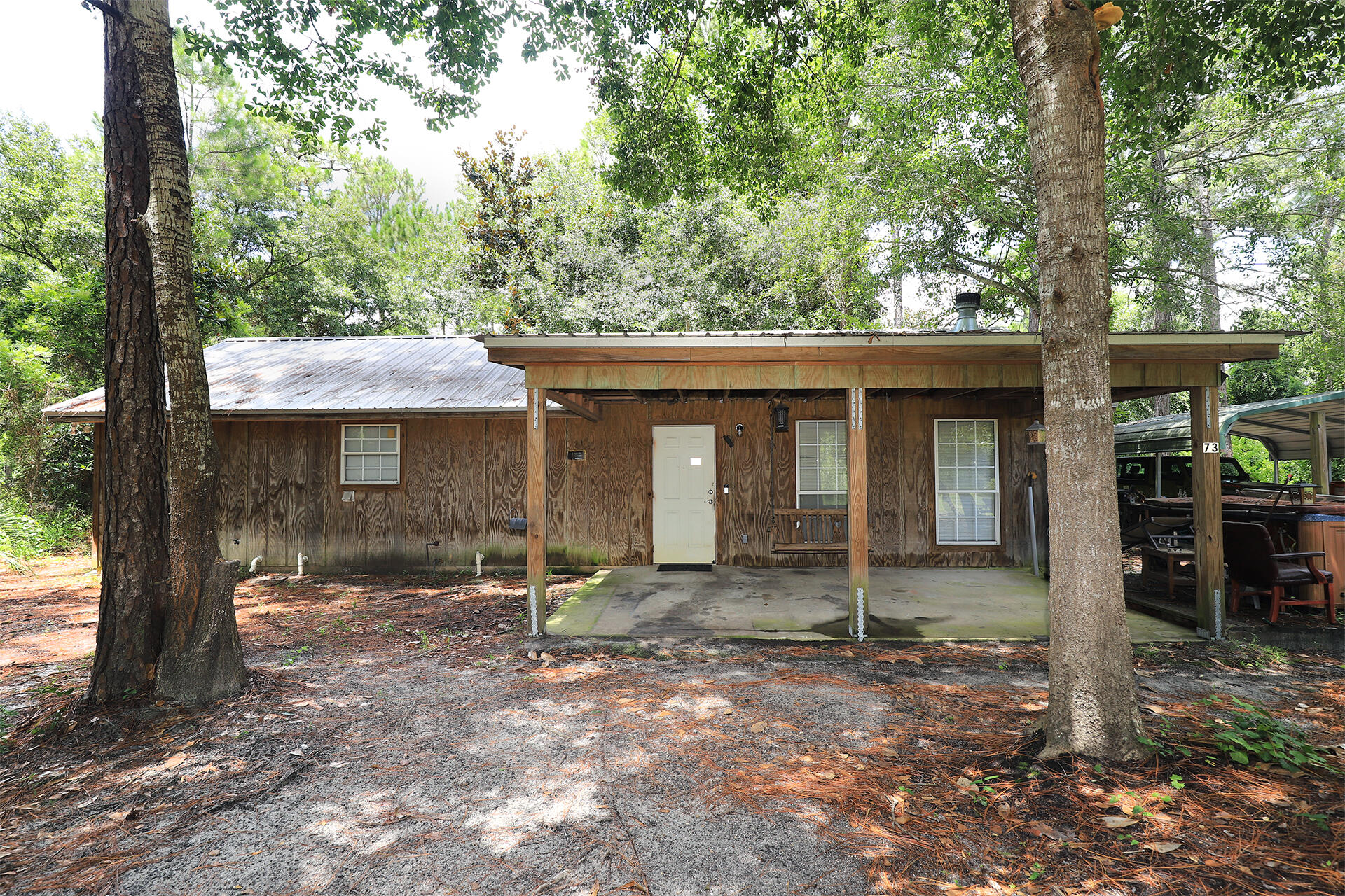 This solid  built and energy efficient home was built with  2x6 studs, shear walls and a tin roof... designed for low power bills,  low maintenance, and also easy functioning floor plan as a small house to move through. The home is  1 story  with  2 bedroom /1 bathroom open floor plan, wide hallways, spacious bedrooms and bathroom giving space to move around. Large living room with wood burning fireplace and tile floors. Bead board walls give the home the unique Florida cabin look.  The exterior of the home is pressure treated wood. Half acre lot with 2 driveways providing plenty of  space for multiple cars, boats, and  RV (with utility hookups on the lot). A car port is in one of the driveways.  There are no neighbors on either side of this home which provides  privacy yet still in the heart of Santa Rosa Beach  within 10 min to beach, shopping, restaurants. see. 
There is additional land available, .50 acre parcel is  for sale as well see MLS #95328