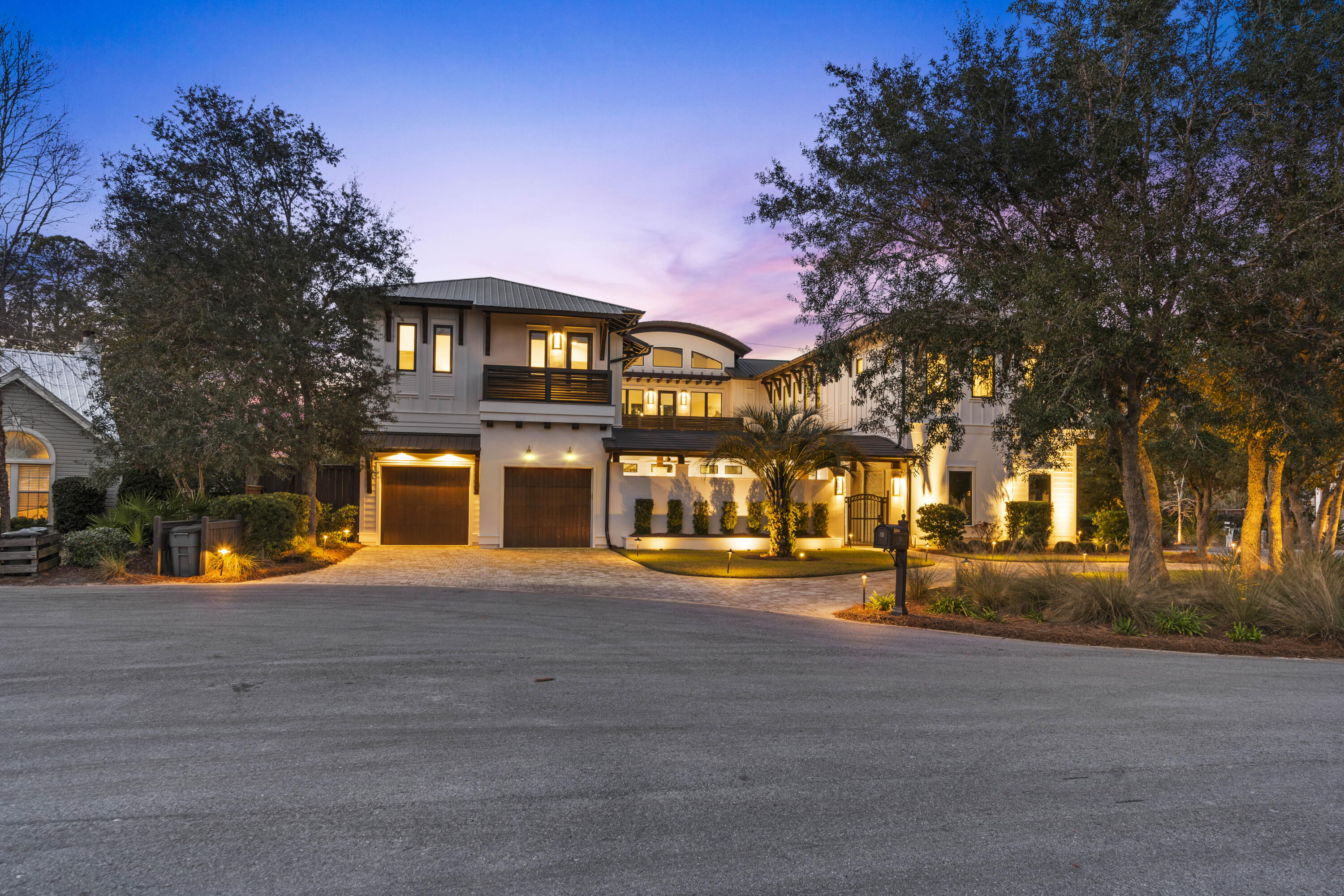 Step into your own private sanctuary—an exquisite modern estate nestled in the highly coveted Old Seagrove community. This architectural masterpiece seamlessly blends sleek contemporary design with the timeless warmth of coastal living.
As you walk inside, you will be welcomed by soaring 30-foot ceilings and a dramatic iron floating staircase, setting the tone for the elegant interiors of this coastal masterpiece. The expansive open-concept living space features porcelain tile flooring throughout the entire first level—all with heated flooring for added comfort. The chef's kitchen is a dream, featuring dual Sub-Zero refrigerators, dual Wolf ovens, dual dishwashers, an oversized butler's pantry, and a striking 16-foot quartz waterfall island. Hurricane impact-grade sliding glass doors lead from the kitchen to the serene courtyard, seamlessly blending indoor and outdoor living.

Entertain with ease in the spacious living area, complete with a stylish wet bar and a built-in Sonos surround sound system. The private primary suite on the main floor overlooks the tranquil courtyard and pool, with motorized Hunter Douglas shades and a spa-like ensuite bath featuring floating vanities, a soaking tub, and a massive walk-in rainfall shower.

Upstairs, the east wing hosts a large media lounge with an art gallery that leads to an additional luxe primary suite with ensuite bath and walk-in closet. The west wing features three more guest bedrooms, each with private baths and generous closets.

The private courtyard is an entertainer's dream, featuring a wireless-controlled saltwater heated pool with a cascading water fountain that flows seamlessly into the design. A stunning mosaic-tiled fire pit is surrounded by built-in seating, creating the perfect gathering spot for cozy evenings. The fully equipped summer kitchen includes a premium Wolf gas grill, Sub-Zero refrigerator, and sinkideal for effortless outdoor dining and entertaining. Practical touches like a 3-car garage, circular driveway, and dual laundry rooms (including a built-in dog wash station) elevate everyday living. All just moments from the white-sand beaches and charming communities of Seaside, WaterColor, and Grayton Beach.

This remarkable home offers the ideal blend of luxury living, coastal elegance, and everyday convenience in one of 30A's most iconic neighborhoods.