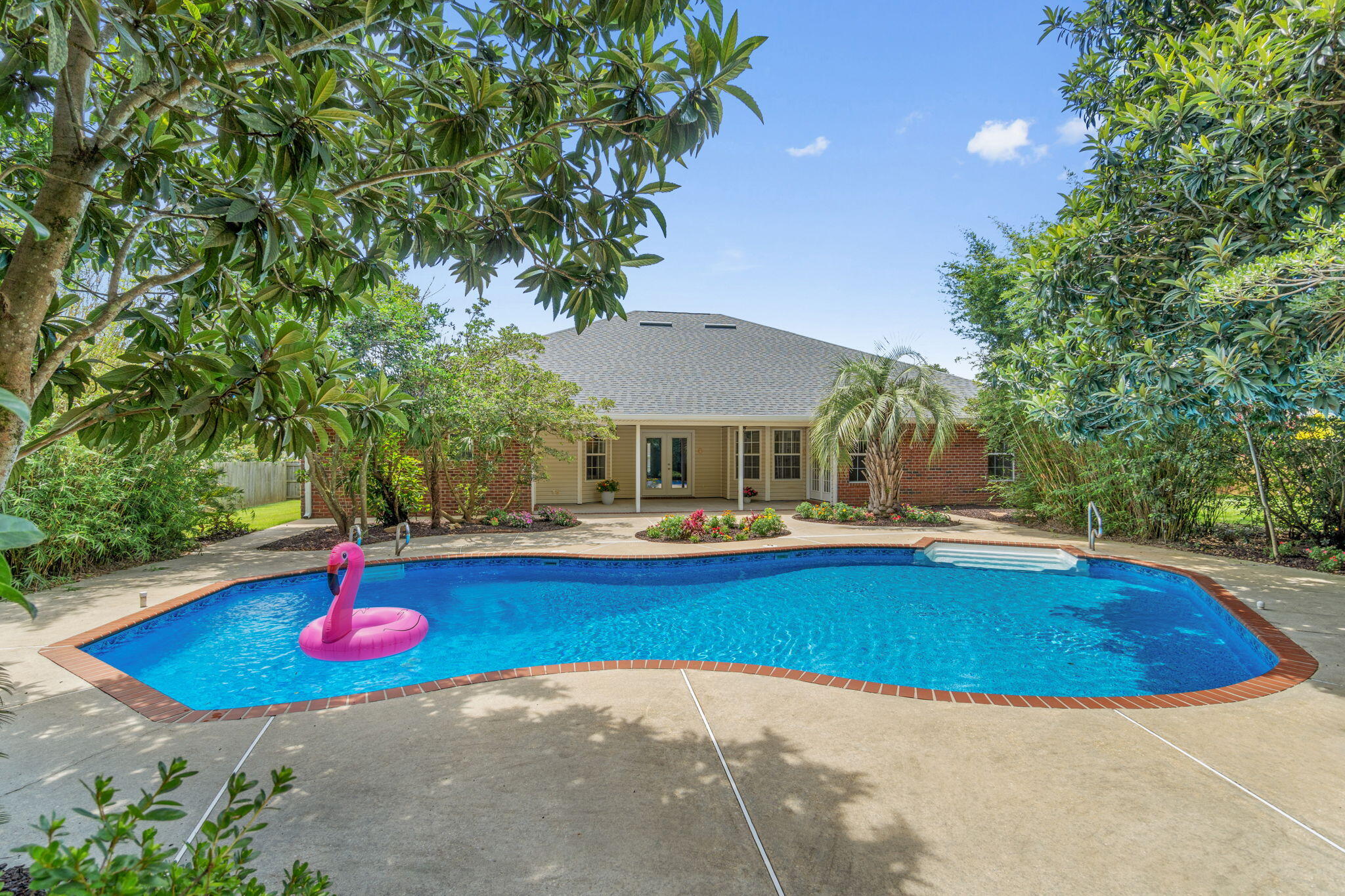 Welcome home to the tropical pool oasis you're never going to want to leave! This stunning and move in ready four bedroom (plus a formal dining room and bonus space/office!), three bathroom home is located in the desirable Gardenbrook subdivision.  with an in ground pool on a half acre lot surrounded by lush tropical and mature landscaping that will give you the private retreat you've been dreaming of. The expansive list of seller updates shows the pride of ownership and care taken with this home and you'll have peace of mind with a new roof installed in 2023, an HVAC system replaced in 2020, a new water heater installed June 2025, a new pool liner and pool filter also just installed in 2025, AND a whole home generator!   

You'll appreciate the curb appeal with the stunning weeping mulberry tree by the brick mailbox and crepe myrtles in the center yard garden. Step through the new front door into the foyer and you'll immediately love the newly installed LVP flooring that extends throughout the entire house with no interruptions and the freshly painted interior! Just to the right of the foyer is the office/flex room and to the left is the formal dining room, both with oversized fans, with a doorway leading into the kitchen. The living room is enhanced with an electrically switched decorative ledge and a gas fireplace with an elevated hearth and two moveable showcase lights. Other extras include surround sound in the walls and ceiling and extra wall outlets. The stunning kitchen features stainless-steel appliances, new quartz countertops, solid wood cabinets, a functional island with electricity, recessed lighting and a walk in pantry. 

This is no cookie cutter home, this home was tastefully upgraded and modified from day 1 by the original (and only) owner! The split floor plan of the home allows for privacy, with two great sized bedrooms and a full bathroom off the living room, and an "in-law suite" off a hallway behind the living room with a walk in closet, it's own private bathroom, and access to the back patio (all bathrooms feature quartz counters, undermount sinks, and upgraded hardware and fixtures!) The owner's suite is nestled off the eat in kitchen area (where you can enjoy your coffee and a fantastic view of the pool!) and is a great oversized retreat complete with a trey ceiling and private access to the back patio as well! The owner's en suite features a massive 6'3"x16'4" walk in closet, a corner jetted soaking tub, double vanity with extended makeup counter and new quartz counters (matching the kitchen), a private water closet, linen closet, and a walk-in shower that's getting a brand new glass door installed shortly! 

Exit out the brand new back doors and you'll see why the backyard truly has the WOW factor and is made for entertaining, relaxing, and making memories! The in ground Crystal Lake pool has an additional 1 foot of depth for extra fun pool days and is surrounded by a private oasis of landscaping where you'll have total privacy from neighbors! Tucked into the canopy of trees are some hidden spots people of all ages will enjoy, perfect for enjoying popsicles on a hot day or tucked away reading a book, but the backyard was designed with several large grassy areas to enjoy. The fully fenced in backyard also has 30ft tall bamboo along the back of the property providing the ultimate tropical retreat, and when the backyard is in bloom it will take your breath away. 

You truly don't want to miss this well maintained gem. Welcome home!