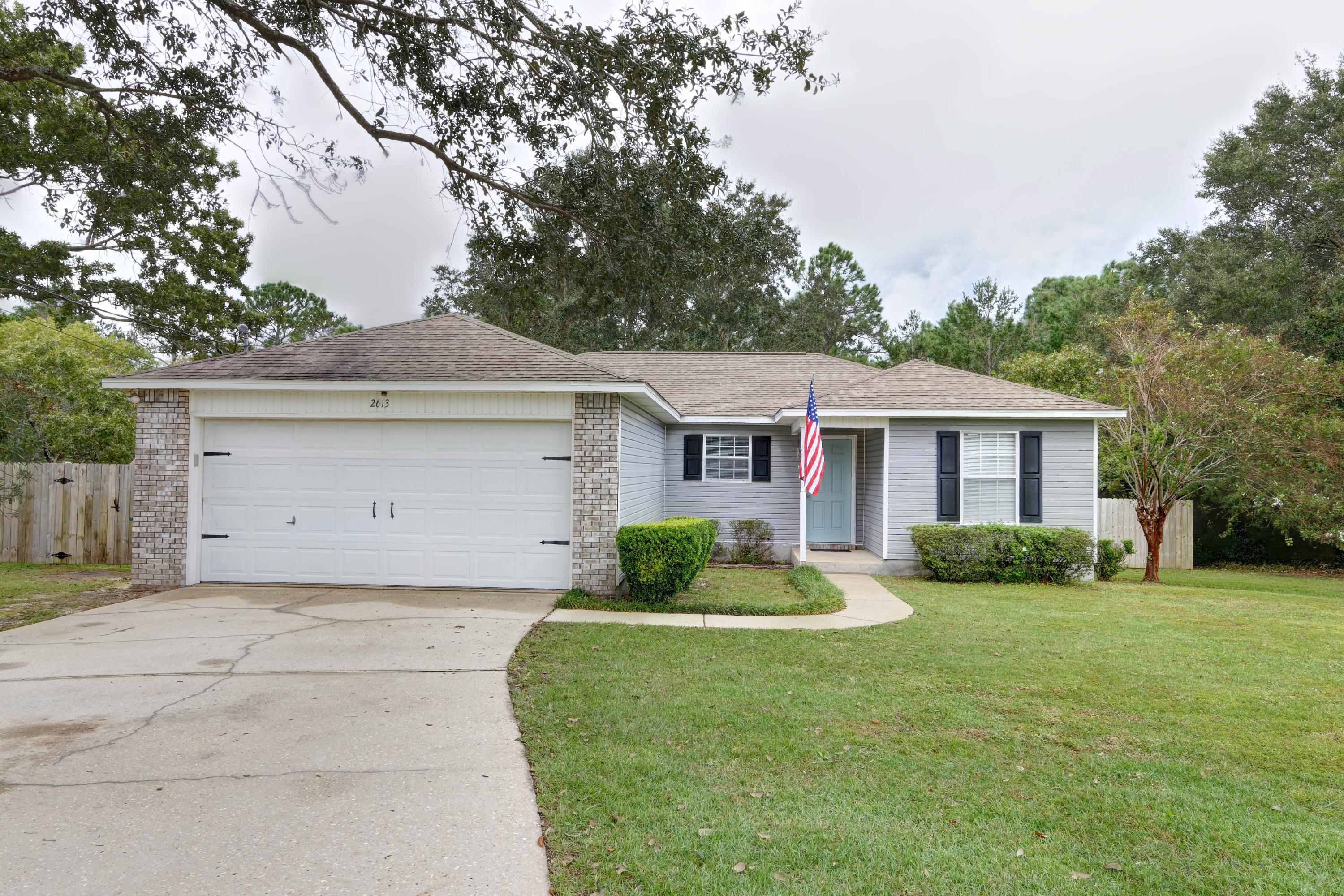 *Rare find!* This adorable and affordable east Navarre retreat features 3 bedrooms/2 baths on a large 0.76 acre lot! Renovated with updates like luxury vinyl plank flooring in the common and wet areas, carpet (only 2 years old) in the bedrooms, and updated light fixtures this move in ready beauty is a perfect full time residence or investment property! Walk through the front doors and you'll love the open concept and split floor plan, with a kitchen featuring granite countertops, stainless appliances, a breakfast bar with room for seating, a pantry, and eat in kitchen space. The living room features a vaulted ceiling, and on one side you'll find the master bedroom with an updated bathroom and walk in closet, and the other two bedrooms and shared bathroom on the other. Exit the back door  and you'll love the spacious fenced in backyard and yard building for storage, but the lot extends far behind the fence with a gate to access the rest of the property so be sure to check out the parcel map in the photos! The washer and dryer hookups are located in the two car garage. Don't miss out on this great east Navarre location just minutes away from beautiful beaches, Hurlburt Field, A-rated schools, and other community amenities!