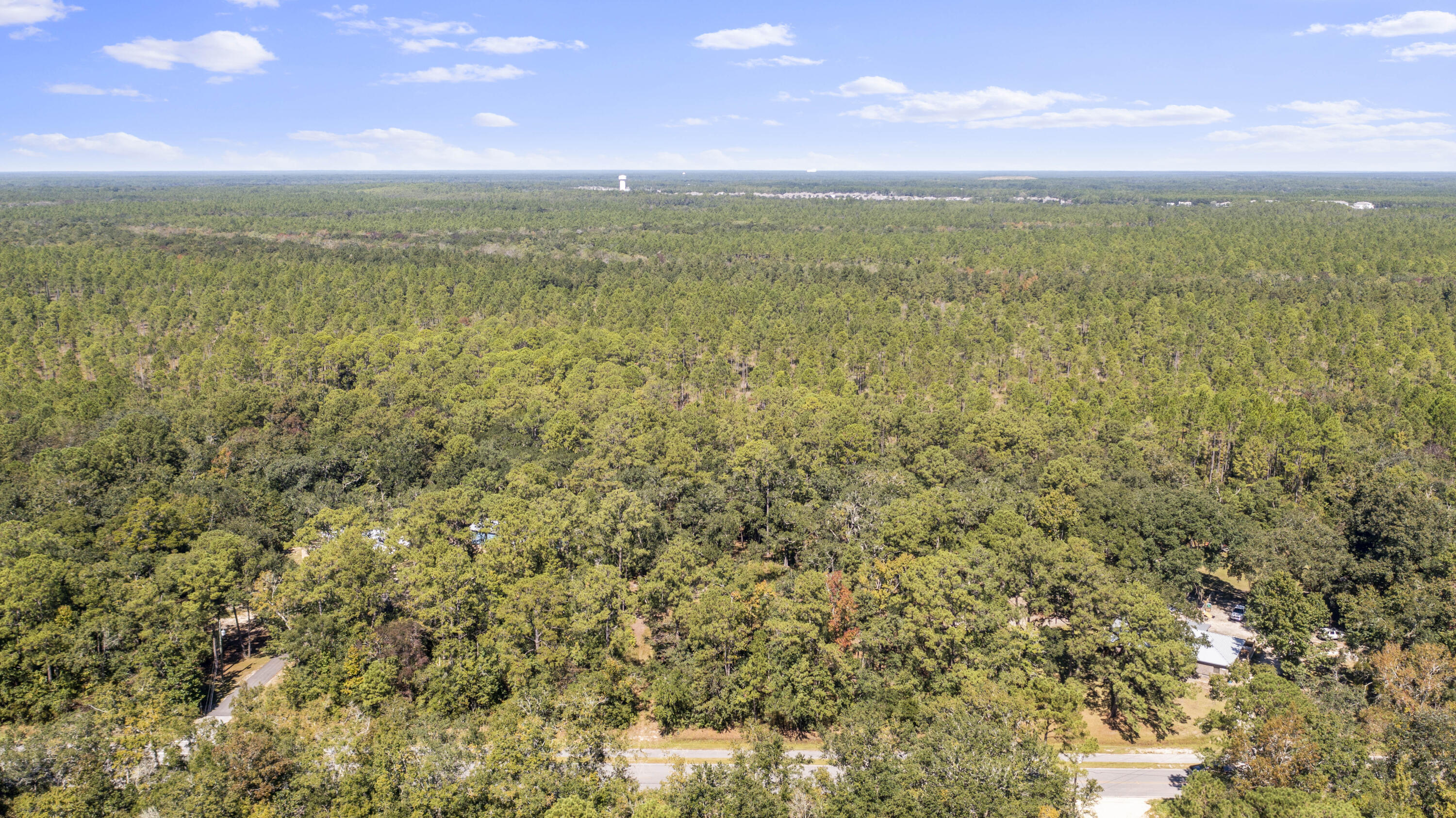 This is the lot you have been looking for!!! Just under an acre with no HOA *and* paved road frontage! 6 loads of fill dirt are already on site for you to use for your site prep before building which is a good amount of savings. This lot is high & dry, and free & clear of wetlands. The sellers have a full set of plans for a 2,400 sqft home with an additional 2,000 sqft building that has already been approved by the county that can be included with an offer acceptable to the seller.  This homesite is in a very convenient area on East Bay Loop/83A East, a very popular and quiet part of Freeport near the Bay. Marina Village is very close, along with multiple public boat ramps within 5 minutes. This lot was annexed into the City, so you'll enjoy a discount on future utility bills, plus have City-resident amenities such as the swimming pool complex. The City of Freeport also upgraded the water/sewer infrastructure along the front boundary so you will not have to use a septic system. Mature trees offer great privacy and gives you the perfect ambiance for you to build your dream home! This oversized lot will provide you with all Freeport has to offer. Water tap fee has been PAID.