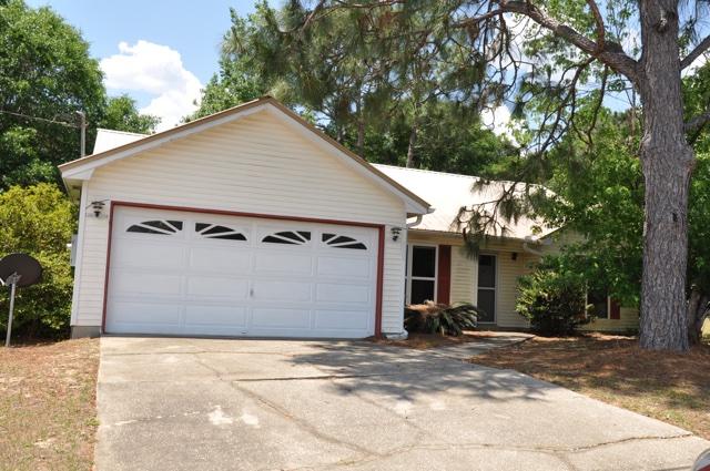REO. Great home in south Crestview! Home features a great split bedroom floorplan, formal dining room, and a welcoming fireplace in the living room. The kitchen includes an island for spacious meal preparation and a pantry to store all of your kitchen essentials in. Because the home backs up to the woods, you will have a lot of peace and quiet in the backyard. Home features a Florida room where you can entertain guests and relax in after a long day. The backyard also comes with a workshop where you can store tools, work on projects, and so on. Because this home is conveniently located south of I-10, you have a quick commute to Duke Field and Eglin AFB. Being sold AS IS.