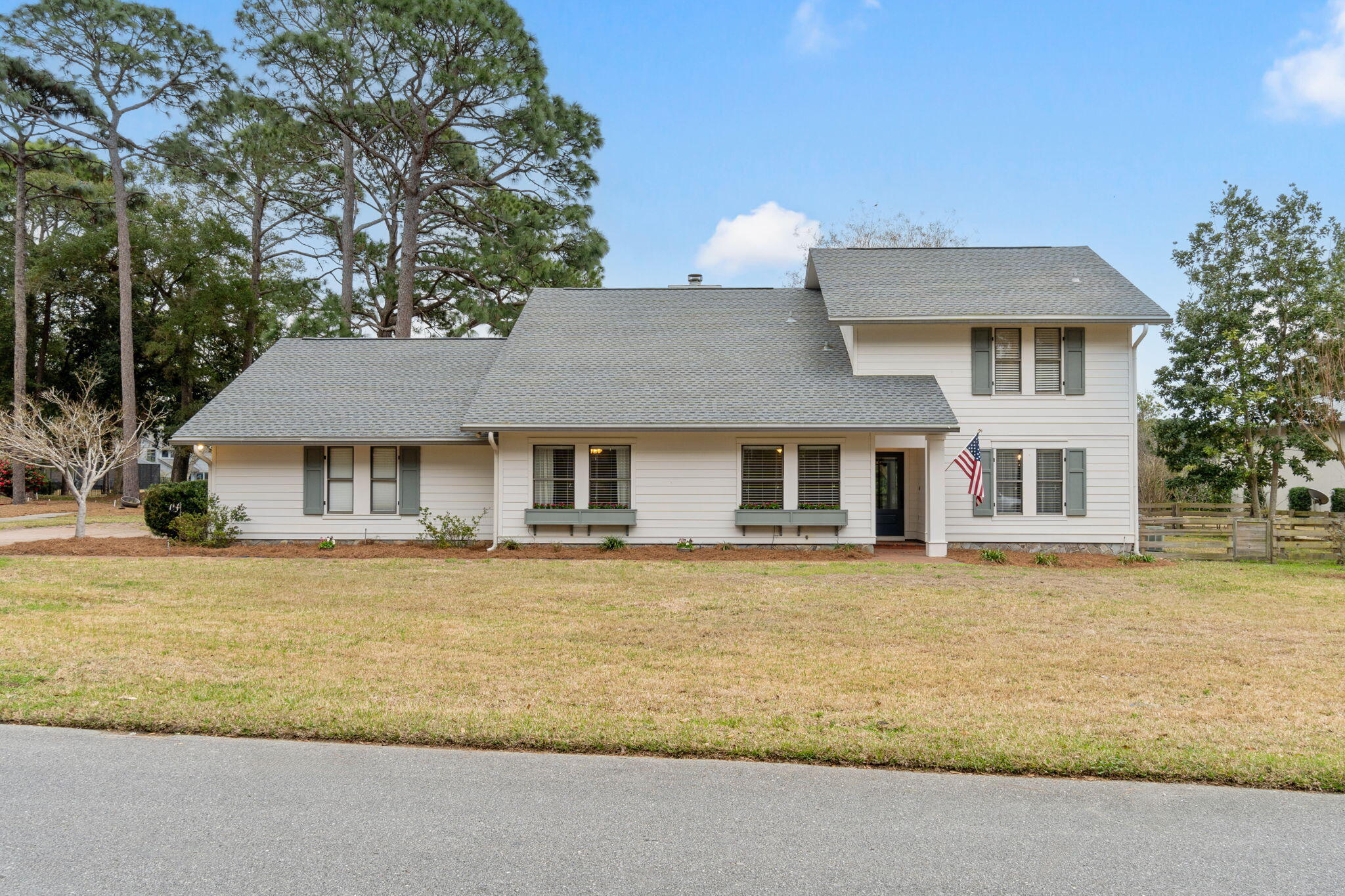 Absolute gem in Bluewater Bay ideally located on green #5 of the Bay Golf Course.  
On your arrival you'll be greeted by a spacious paver driveway with plenty of room for your vehicles plus your golf cart, flowering window boxes, mature trees, pond and sunset views, and so much green space.  

The outside charm expands inside the home. As you step in you are greeted by an amble sized entry and spacious formal dining room that flows into both the living area and beautiful chef's eat in kitchen.  You will notice thoughtful updates throughout the entire home creating a modern feel, but the kitchen is a show stopper, beautifully remodeled with quartz countertops, coffee station, stainless steel appliances, and a spacious island. The living room ceilings are two stories in height creating a massive feel to the space. The soaring wood-burning fireplace is complemented by a wall of windows and doors that beckon you outside through any of the TWO  sliding glass doors, a true centerpiece to the room.  

Continuing on the main floor, featured are the hardwood floors, built-in cabinetry, beautiful barn door, spacious laundry room, and generously sized bedrooms. The two main floor bedrooms share a glamourous remodeled bathroom with a sizable walk-in shower to include a built in Bluetooth speaker. Making our way upstairs leads to a loft space that may serve as your office, playroom, and more.  The spacious primary suite is complete with a renovated ensuite bathroom featuring a stunning soaking tub and a separate oversized tile shower with multiple shower heads. From the primary suite glass doors open onto a private screened in second-story balcony retreat, offering views of the golf course.

Conveniently located off the oversized garage, the laundry room includes a sink and a fully remodeled half bath. The property also features a bonus room within the garage, that is heated and cooled, offering versatile possibilities as a workout space, workshop, or climate-controlled storage area. Stepping outside, you'll discover two screened-in porches, a patio, fenced yard with doggy door plus fenced in run, and lush landscaping. The Bluewater Bay Community offers an array of resort-style amenities, including golf, swimming, tennis, a marina, and dining options. Boasting top-rated schools and close proximity to Eglin Air Force Base and the stunning white-sand beaches of Destin, this is a home where you'll be delighted to settle in and call your own.