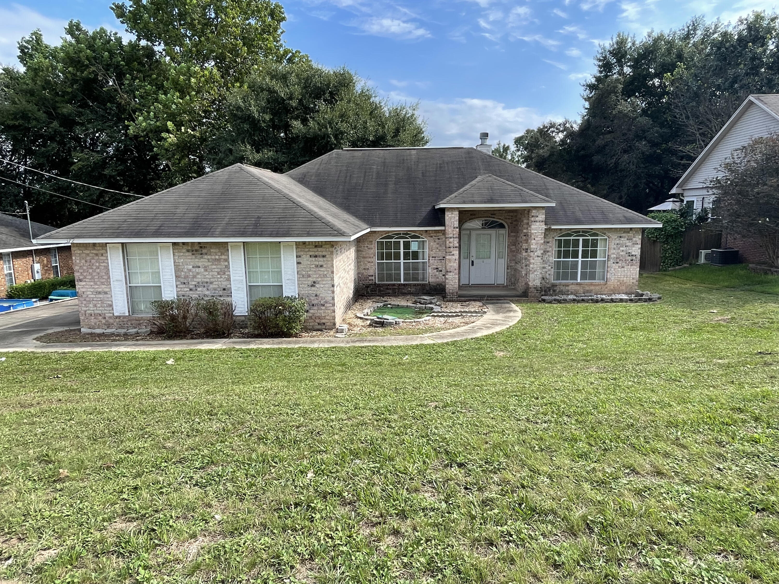 Located just a few mins from interstate access, shopping, and a short drive to Duke Field, this REO home just might be right up your alley. Built in 2002, this all brick 3 bedroom 2 bath split bedroom design home has vaulted ceilings, fireplace in living room, separate dining and breakfast nook and a surprisingly large open kitchen. Masterbath is oversized with separate shower as well as a large garden tub, but what really makes this home pop is the massive bonus room off of the rear of the property. With approx 674sf of vaulted space this room has tons of potential for a super amazing game room, he/she cave, craft room and more. Home does need some work, and therefore, may not qualify for all types of financing, but this home is a definite must see. Call today!