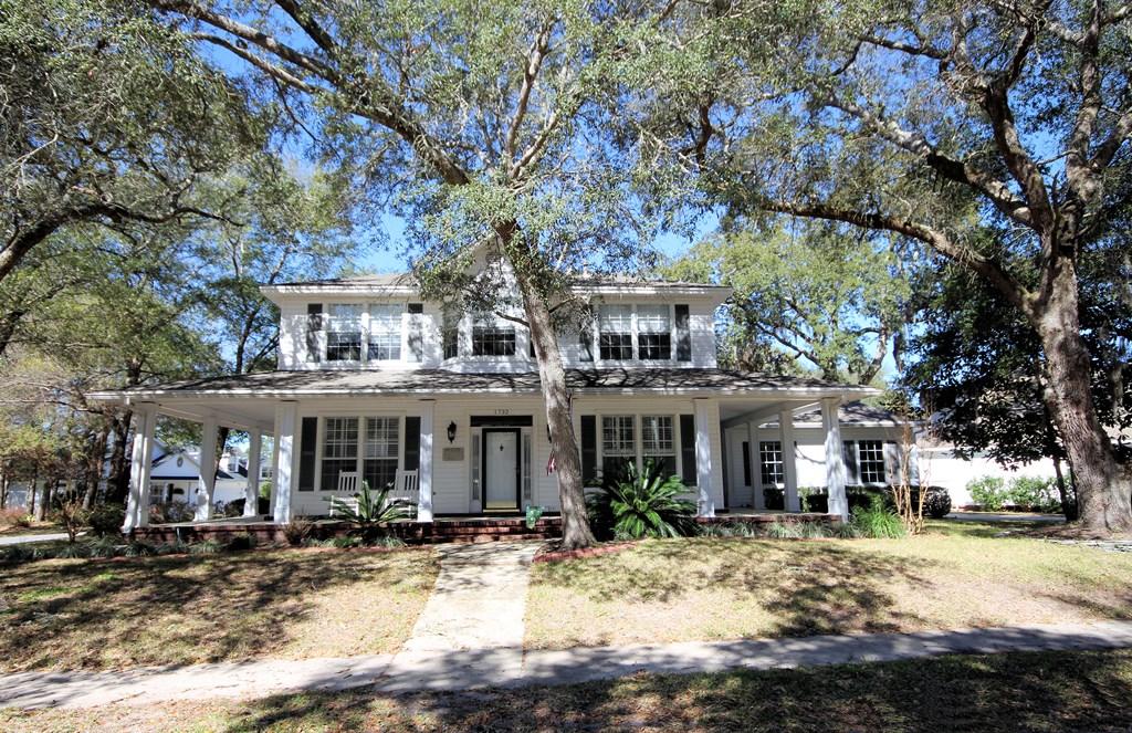 Step back in time into the charming community of the Village of Bolton located in gated Parkwood Estates of Bluewater Bay in Niceville. This stately colonial home is within an easy walk of one of the BWB pools, the sandy shore of Rocky Bayou and the shops and restaurants at Merchants Walk as well as Bluewater Elementary school, an A+ rated school! The home is located on a corner lot with a huge welcoming wrap around porch and oversized side entry garage. This home offers a more traditional floor plan with the master suite and two additional bedrooms upstairs and an open floorplan with an additional guest suite downstairs. Upon entering this fine home through the foyer, you will notice the wide plank wood floors and smooth ceilings accented by crown molding. To the right, you will find a formal dining room and on the left is the guest suite. The foyer opens to the large family room with a beautiful gas fireplace that is open to the breakfast room and kitchen. The kitchen features tile floors laid at a diagonal, "Santa Rita" granite counters, custom cabinets and stainless appliances. Along the back of the house behind the family room is a screened porch as well as a raised deck off of the kitchen.  Downstairs you will also find a large laundry room with built in cabinets. Upstairs is the master suite with a separate office area or an extra closet tucked into the corner of the room. The master bath features a dual sink vanity, separate shower, soaking tub and "his and hers" closets. Also upstairs are two additional bedrooms that share a convenient Jack-n-Jill bath. Additional noteworthy items include custom window treatments, plantation shutters, poured concrete edging and beautiful landscaping. Welcome home to the Village of Bolton, a "front porch" neighborhood where families gather together to celebrate life!