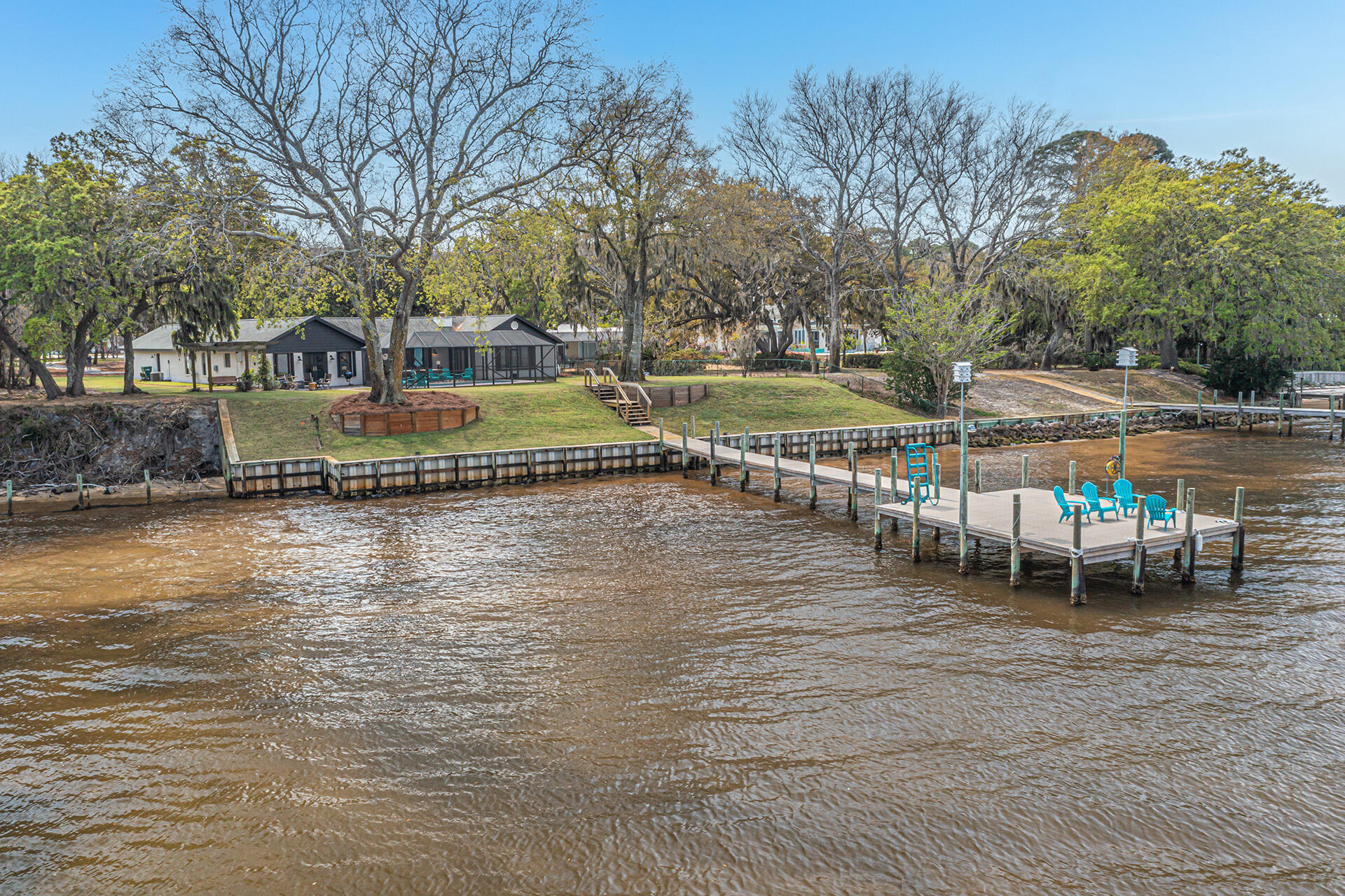 Perfectly situated, high and dry, in the heart of Destin on Prestigious Indian Trail, easily one of Destin's most sought after locations, sits this elegant, secluded, one level, 4 Bedroom, 3.5 Bath, 3036 square foot bay front estate home with two master suites, a screened and heated saltwater gunite pool, an oversized 3 car garage on a very private 1.2 acre lot including 100 feet of waterfront directly on Choctawhatchee Bay.  This fabulous lot includes mature shade trees, manicured, irrigated, freshly sodded lawn as well as open natural spaces, there are even honeybees making honey on the property.  Brick pavers form the driveway leading from the road to the house and also from the pool area down to the new dock with ThruFlow decking material to help limit dock damage from future storms. The entire waterfront is protected by a commercial grade seawall, installed in 2014, take a look at the photos it was obviously built to stand the test of time.  Other features and recent upgrades include new: pool heater, screen, water leveler, 7" gutters with leaf filters, sewer lift station, 2 AC units (Bosch and Carrier), luxurious kitchen with water views, granite countertops, stainless steel appliances including Kitchen Aid gas oven/range, separate wine refrigerator and standalone ice machine, cabinets with soft close drawers and doors, Navien tankless  gas water heater, wood look vinyl plank flooring and tile throughout....no carpet, 400 amp electrical service, Honda partial home backup generator, ceiling fans, upgraded lighting and plumbing fixtures.  The elevation of the home itself is 12.5 feet above sea level, well above the 100 year flood plain, no flood insurance is required, elevation certificate is in the documents section of the listing.  No HOA fees or arbitrary hoops to jump through because this home is not in an HOA!  And maybe the best feature of all, this wonderful estate home is only 2.2 miles from Destin Executive Airport (DTS).  It would make a perfect home, or second home, for an entrepreneur or corporate executive that really enjoys the Destin lifestyle!