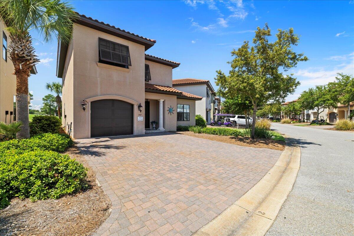 THE ONLY HOME AVAILABLE ON THE GOLF COURSE WITH A PRIMARY SUITE ON THE MAIN FLOOR AND A ONE CAR GARAGE!  Tee off in style with this stunning home on the #5 fairway of the Baytowne Golf Course. Enjoy sunsets and fireworks from your private patio and balcony. Featuring a convenient PRIMARY suite on the main floor and an open concept living/dining area complete with a chef's kitchen and coffee bar, this home is designed for both comfort and entertainment. Upstairs, find a second living area, a 2ND PRIMARY suite, and two more bedrooms with en-suite baths. Perfect as a primary residence, second home, or vacation rental, this fully furnished coastal gem includes a garage and two golf carts. Swing into your dream lifestyle today!