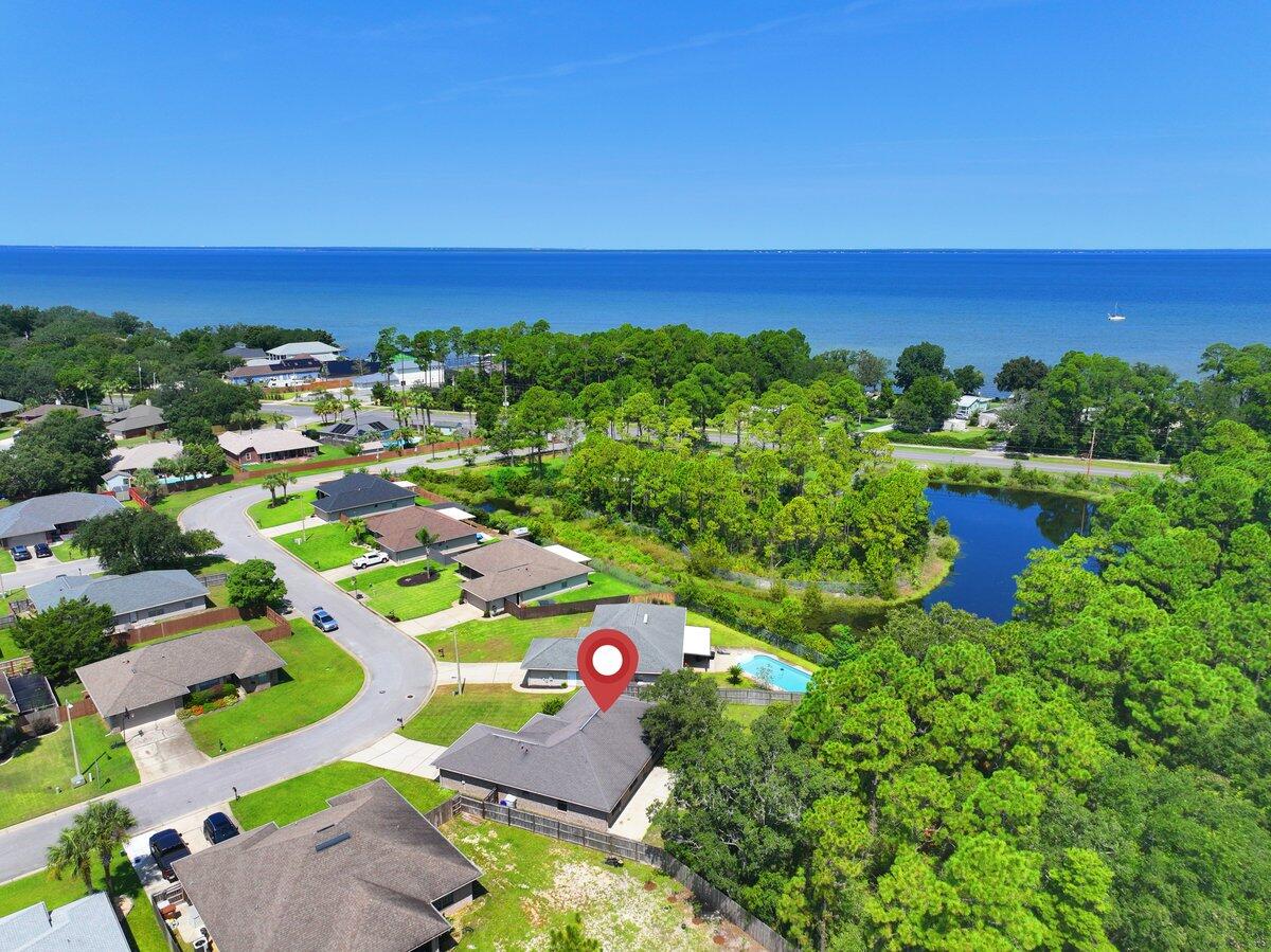 This is the perfect family home that is move in ready! The Seller is offering $10,000 in concessions to assist with the Buyer's closing costs, new roof, and or rate buydown. Welcome to your own piece of paradise in the Bay Pines subdivision of Gulf Breeze, FL. This home has a great floor plan that is spacious, and open. The kitchen has tons of storage and counter space as well as a pantry for extra storage. The master suite has a large garden tub with separate shower. There is a double vanity and walk in closet. The large back yard has a privacy fence and backs up to a wooded area for added privacy.  Shed in the back as well for your outdoor equipment. The neighborhood is centrally located off Hwy 98 and East Bay Blvd., between Pensacola and Ft. Walton Beach. Ten minute drive to beautiful Navarre beach.  Fifteen minutes to Pensacola Beach.  Take family bike rides in the evenings, or early morning jogs with your dog down the paved walking path that follows East Bay Blvd.  Just minutes from Woodlawn Beach Boat Ramp, and Soundside Beach as well.  Bay Pines is a quiet and friendly community, and this home is a prime example of coastal living at its very best.  Come and see for yourself!