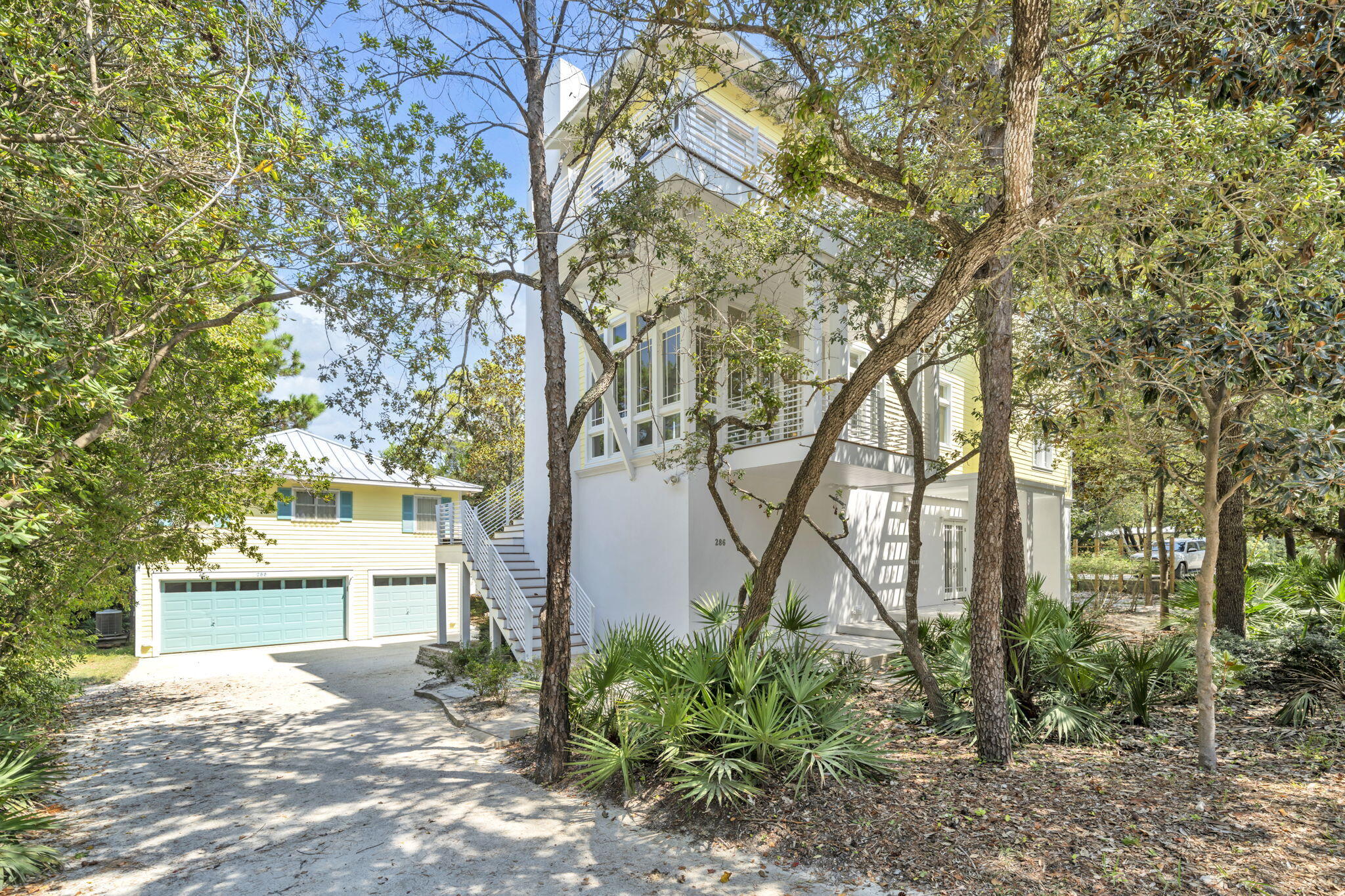 Nestled under Old Seagrove's iconic tree canopy and just two blocks from both the beach and Seaside, this three-story contemporary home (4645 sq-ft) blends architectural pedigree with coastal charm. Designed by acclaimed Tom Christ of Christ & Associates, a Seaside Prize-winning architect whose visionary work has shaped much of 30A's distinctive style.
The main home delivers light-infused living with expansive covered porches and soaring floor-to-ceiling windows. On the first floor, you'll find a guest suite with private bath, walk-through laundry, and a massive unfinished flex space — perfect for a future primary suite, media room, or game lounge.On the second floor, the open-concept living and dining area opens onto porches on both sides creating an ideal indoor-outdoor flow. A guest suite with a walk-in shower rounds out this level.
The third floor is a private retreat: the primary suite stuns with wall-to-wall windows, a private balcony, dual closets, and a spa-worthy bath with double vanity, garden tub, and walk-in shower. Plus, there's a second guest room with pre-plumbing area ready for an ensuite bath.
 Carriage House (781 sq-ft) 2 bedrooms, 1 bath and a full kitchen, perched above a 2-car garage complete with a golf cart bay and 11 x11 air conditioned space. Ideal for multi-generational living, vacation guests, or rental opportunities.
Designed by a local design legend, this Seagrove gem offers the best of both worldssmart, stylish architecture and unbeatable proximity to the Gulf and Seaside's vibrant hub.***Buyer is responsible for personally verifying details about this Any information contained in this listing is believed to be accurate but not guaranteed.***