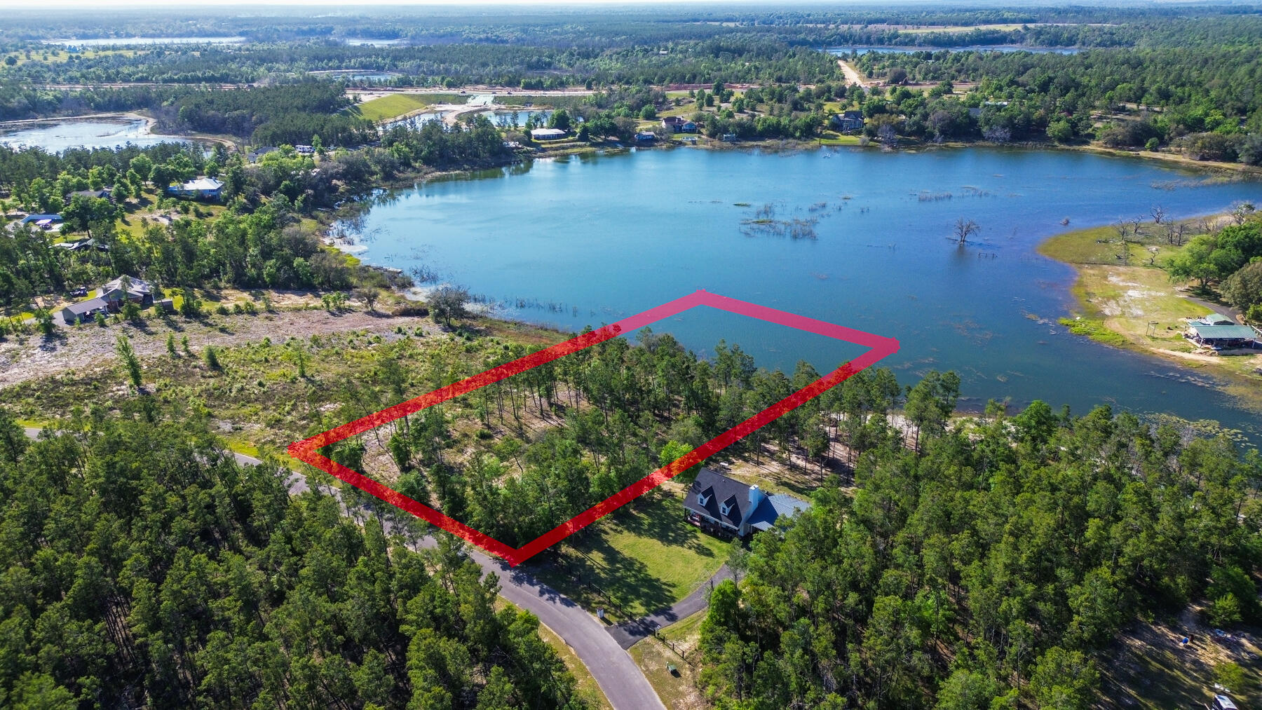 Looking for your own private slice of paradise? This 2-acre vacant lot on a lake is the perfect opportunity to create your dream home or cottage. Boasting 169 feet of lake frontage, you'll have stunning views of the water and plenty of space to enjoy all the activities that lakeside living has to offer.

The property is just a short drive from Lynn Haven and Panama City. Located in a peaceful and serene setting, this property offers a rare opportunity to escape the hustle and bustle of city life and enjoy the tranquility of nature. Enjoy all kinds of water activities while taking in the scenic views. If you are looking to build a lakefront home, this is a must see! 

Pine Ridge Drive offers underground electric. A boundary and topographic survey from 2022 is included in the sale.