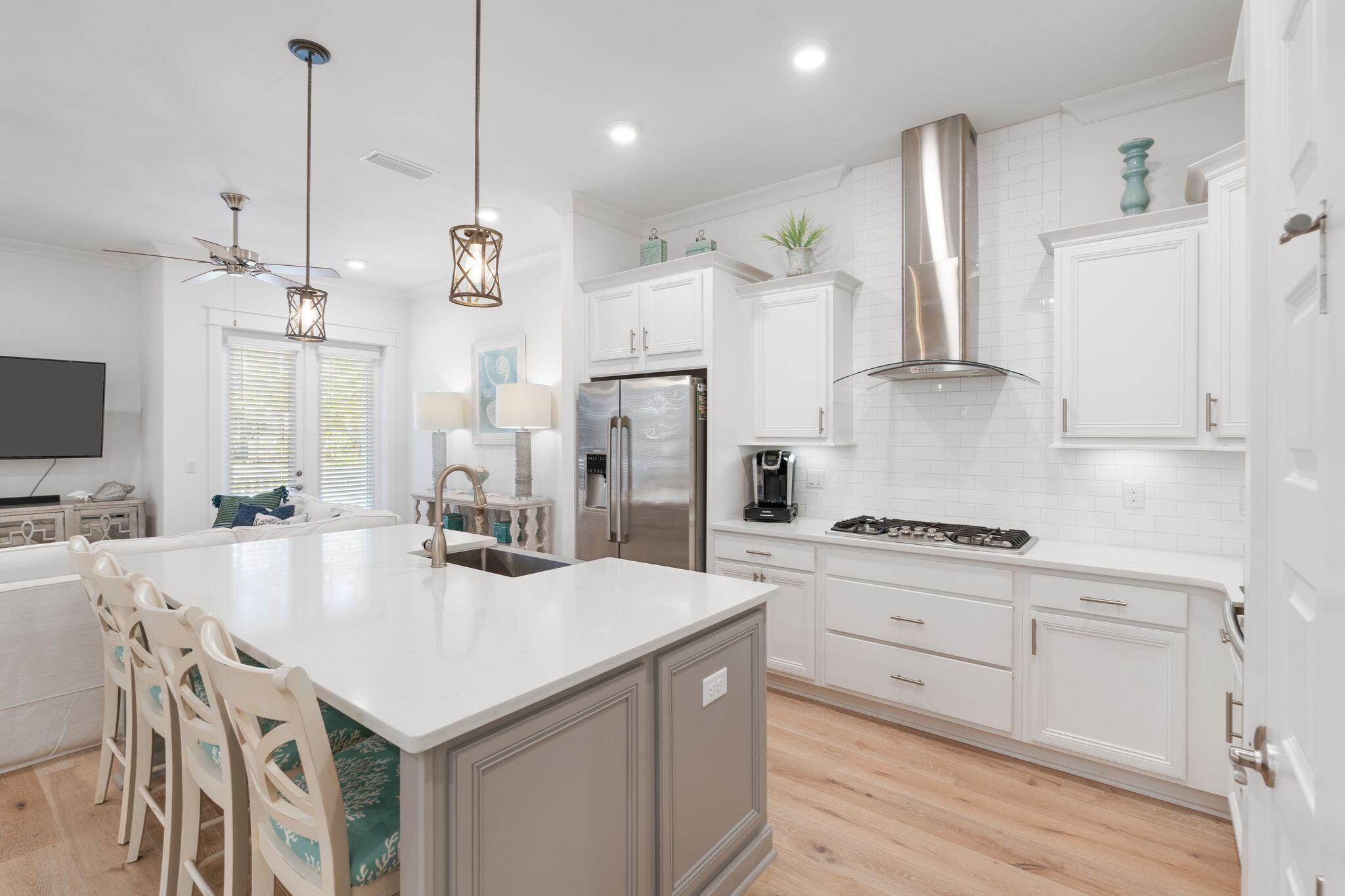 In a prime location on 30A, this turn-key townhome is perfect for your next investment or second home! Ready to rent with a golf cart included and over $95k in rental projections. This home features coastal furniture, light hardwood floors, and is fully stocked with all the essentials. In excellent condition, this end unit is on an upgraded lot as this unit backs up a spacious wooded area - great for privacy from neighbors. A large open deck spanning the length of the unit makes this a private, very appealing coastal retreat overlooking the forest. A two-car garage, upgraded stainless appliances, tile backsplash, quartz countertops, 10' ceilings, washer and dryer, and coastal furnishings makes this the perfect luxury investment in the heart of 30A!