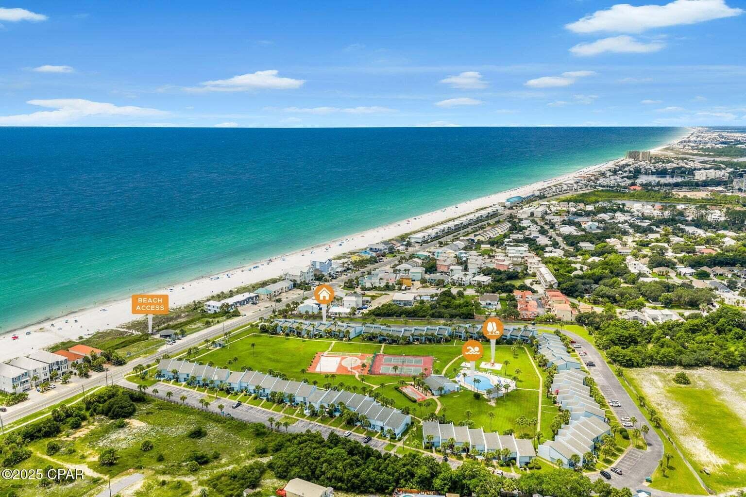 **Property is designed as a townhome, but is legally recorded w/ the county as a condo* Property also listed as condo in MLS #987814**  Welcome to Sunnyside Beach & Tennis Resort Unit #6 — a beautifully renovated 2-bedroom condo with a spacious loft and 2.5 baths, offered furnished and turnkey! This thoughtfully redesigned home underwent a full remodel beginning in 2018, maximizing both functionality and comfort for full-time living, a luxurious beach getaway, or savvy vacation rental. Inside, you'll find beautiful wood shiplap ceilings throughout, adding to the coastal charm of this unit. The HVAC system was upgraded to improve airflow, including added vents in the upstairs bathrooms and master bedroom. The custom kitchen was designed for entertaining (SEE ADD REMARKS) appliances, including a built-in undercounter ice maker and a beverage fridge. The adjacent dining area boasts a custom driftwood light fixture, and the nearby laundry room includes additional cabinetry and a small deep freezer. The living room offers a cozy electric fireplace built into the TV console, while the downstairs half bath includes a new vanity and linen closet. Every inch of space has been optimized with smart storage solutions, including a large walk-in pantry with custom shelving, a full-size storage closet above the stairwell, a full-size door under-stair storage area, and a pull-down attic staircase. Tile flooring runs throughout the lower level and bathrooms, with oak stair treads stained to resemble driftwood. Upstairs, the balcony showcases custom iron spindles with stained glass inserts designed to mimic ocean waves. Outside, both the front and back areas have been professionally landscaped, and the sale includes all exterior furnishings, fire pit, grills, and storage boxes. The Sunnyside community is very much a family-oriented environment, with interior sidewalks and large green space where children can safely ride bikes and play. The HOA also offers convenient boat and trailer storage for just $100 per month. Sunnyside Beach & Tennis Resort is a highly unique and sought-after community, consisting of only 74 townhome-style residences spread across 20 beautifully maintained acres with 264 feet of deeded beachfront. Additionally, it's the only property in Bay County that features a private tunnel under Front Beach Road, offering safe and direct access to the beach. This rare gem blends coastal charm, modern comfort, and a true sense of community in one of Panama City Beach's most exceptional resort settings.