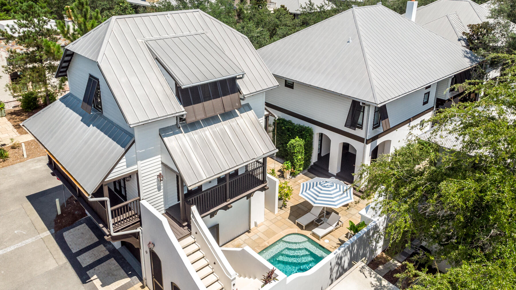 This spectacular contemporary residence is perfectly situated on a coveted oversized corner lot in beautiful Rosemary Beach. High-quality construction is apparent upon entering an inspiring great room with two-story soaring ceilings, a feature fireplace, and a winding staircase. Designer lighting fixtures can be found throughout this 3,322 sq ft home. A gourmet kitchen features all new appliances, a Scotsman pellet ice machine, Cambria quartz countertops, and wood shaker cabinets with soft close doors and drawers. Double doors lead out to an exquisite private outdoor courtyard with beautiful landscaping, a large saltwater pool with all new pool equipment, outdoor fireplace, summer kitchen and water fountain and three outdoor living spaces.... Porches on the second floor offer serene places for relaxing with a cup of coffee or novel on mild weather evenings. In addition to three full bedrooms, the main home also features a loft area, a bunk room and an office.  An ideal primary residence, vacation retreat, or rental investment, this property includes a two-story carriage house for guests with a spacious bedroom, full kitchen, living room, one-and-a-half baths, and a wraparound porch. This home also has a large two car garage and all new HVAC units. This beautiful property is being offered mostly furnished with a small list of exclusions available upon request. 

Rosemary Beach is one of South Walton's New Urbanist Communities offering world class amenities including a tennis center, and boasts stunning West Indies style architecture, almost a half mile of private white sandy beaches, charming boutique community pools and a modern "owners only" club with pool and entertainment clubhouse. With close proximity to Rosemary Beach's Town Center, as well as to well-known restaurants and boutiques, this gorgeous home offers plenty of ways to enjoy some of the area's most popular amenities.