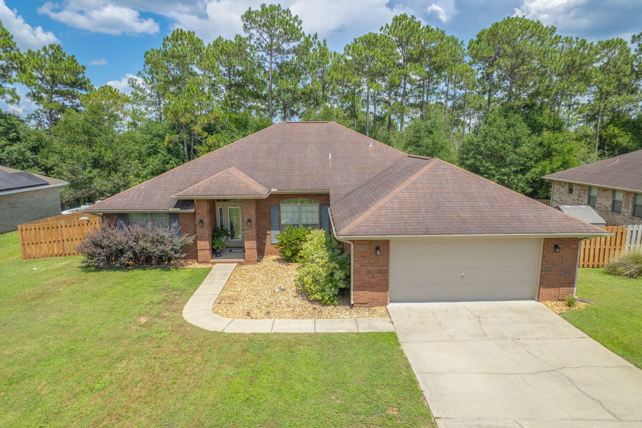 Imagine coming home to this Spacious 4-Bedroom, 3-Bath All-Brick Home in Desirable Alicia Place. This beautifully designed home with a 2-car garage is perfectly situated in the highly sought-after Alicia Place community, south of I-10—offering a quick commute to 7th Group, Duke Field, and Eglin AFB. From the moment you step onto the welcoming covered front porch, you'll feel the inviting warmth and charm this home offers. Inside, you'll find soaring 10-foot ceilings and an open-concept layout that blends comfort and style—ideal for both everyday living and entertaining. Enjoy hosting weekend get-togethers on the back patio while sitting by the fire pit  or preparing meals in the chef-inspired kitchen. FEATURING Stainless Steel Appliances, ample cabinet space, a walk-in pantry, and a breakfast bar perfect for casual mornings. A flex room provides a versatile space that can be used as a home office, playroom, or a second living areacustomized to fit your lifestyle. The split-bedroom floor plan maximizes space and privacy, offering a huge master suite with a spacious ensuite bath, and three additional generously sized bedrooms. Thoughtful touches throughout the home include wood-look tile flooring, abundant storage, and architectural details that set it apart from typical builder-grade homes. The tumbled brick exterior and refined design create a timeless look that's both durable and elegant. This is more than just a houseit's a home your family can enjoy for generations.