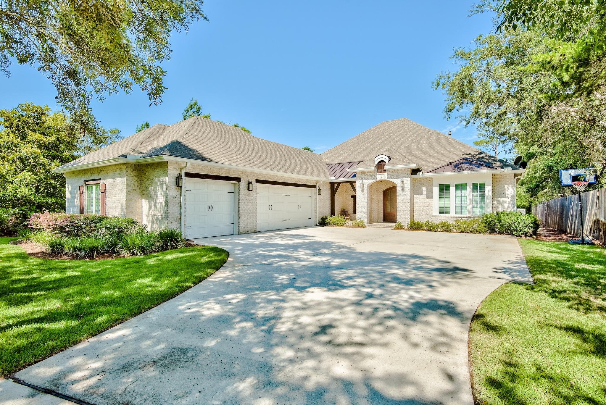 Phenomenal bayou front home situated on an expansive lot offering just over half an acre of true privacy. There is beautiful curb appeal with lush surroundings and covered front porch accented with wooden beams and entry doors. This 4-bedroom home has custom details throughout setting it apart from the rest. Upon entering the home, you are greeted in the beautiful foyer with raised ceilings and hardwood floors throughout. The living area features a stunning coffered ceiling with recessed lighting, a fireplace accented with shiplap and built-in shelving, and large sliding glass doors that offer plenty of natural light and direct access to the covered lanai and screened-in pool area. The covered lanai is great for entertaining and offers a fireplace, large flat screen TV, and summer kitchen. The pool area is screened-in and offers a large deck for sunbathing and a hot tub for relaxing. There is an outdoor shower and a convenient half bath just off the pool which is great for keeping wet bodies outside.

This home boasts 4,149 sq ft and an open floor plan which makes it feel even more spacious. The kitchen is a chef's dream with granite countertops, large island/breakfast bar, gas stove, plenty of storage space with ample cabinets & pantry, tile backsplash, and stainless steel appliances. Just off the kitchen is a dining nook, great for everyday dining. The home also offers a formal dining area for large gatherings. Just off the great room is a wet bar, perfect for mixing your favorite cocktails. The wet bar features glass cabinets to showcase your crystal stemware, mosaic backsplash, a sink, mini fridge, and wine fridge.

The study and all of the bedrooms are located on the main level with an expansive bonus room for the entire second floor. The waterfront master bedroom is very spacious and features a beautiful tray ceiling with recessed lighting, a fireplace accented with shiplap, two walk-in closets, and a luxurious master bathroom. The master bath offers double vanities with vessel sinks, a walk-in tile shower with beautiful mosaic tile, and large soaking tub. The three additional bedrooms are generous in size and two of the bedrooms offer ensuite bathrooms. Upstairs features a large bonus room which is currently a fantastic entertainment space with a bar, pool table, lounge area, and a convenient half bath. This large space has endless possibilities!

The large backyard is perfect for children and pets to play. There is plenty of green space to enjoy between the home and the bayou. There is a great covered dock with electricity, boat lift or two jet ski lifts, and a platform/stairs for launching kayaks and paddle boards. This amazing home on Mussett Bayou offers quick access to fun outdoor activities such as fishing, boating, kayaking and paddle boarding. By boat you pass through Hogtown Bayou to access the Choctawhatchee Bay and can even get to Crab Island within ~30 minutes. Stay protected on the Bayou and enjoy the peaceful setting. Dune Allen Regional Beach Access is just under 4 miles away so you can have your toes in the sugar-white sand along the emerald green & crystal blue waters of the Gulf of Mexico within just a few minutes! This home truly offers everything you need for an enjoyable coastal lifestyle on the water.