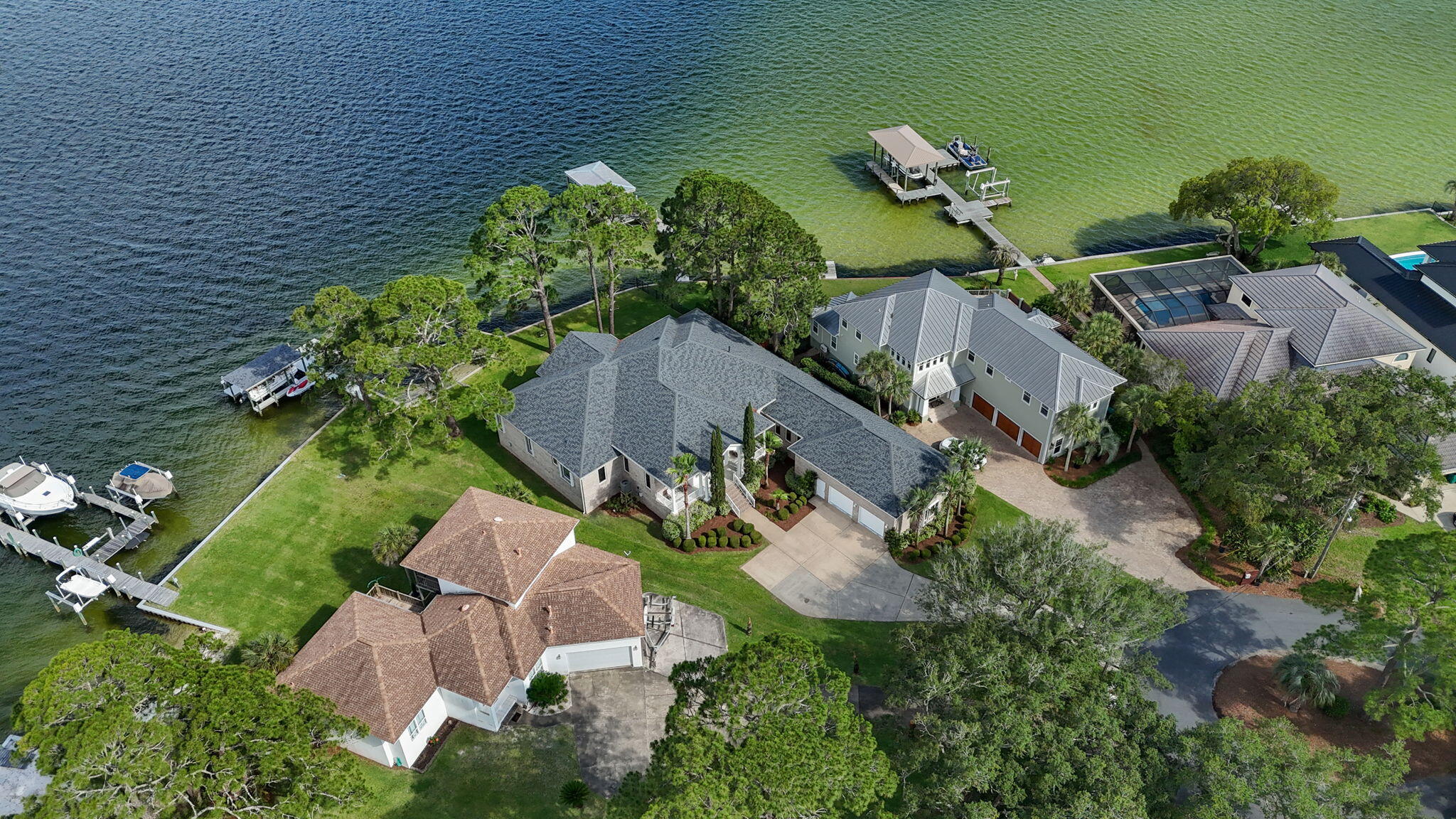 Tucked away at the end of a quiet, private cul-de-sac in sought-after Shalimar, this stunning waterfront property offers the kind of lifestyle that rarely comes along--a setting for stories, memories, and the simple joy of life by the water. With approximately 144 feet of deep water frontage and direct boating access, this is where everyday life feels like a getaway. 
As you approach, a charming front porch welcomes you in, while lush, manicured grass leads the way to your own private waterfront haven. 
Step inside to find soaring ceilings and crown molding throughout, setting the tone for elegance and ease. The open, split floor plan offers a seamless flow between living spaces, and nearly every room is kissed by panoramic water views, from the living areas to multiple bedrooms. The kitchen is a hub of connection and comfort, with generous counter space, a view-filled breakfast nook, and sightlines straight to the water. The living area opens effortlessly onto an expansive back porch, perfect for morning coffee, sunset dinners, or simply taking in the peaceful rhythm of the bay.
The master suite is a true retreat, complete with water views, ample closet space, and a private bath. With 4 bedrooms, 3.5 baths, and multiple AC units, the home is designed for both comfort and functionality. The garage offers extensive storage and even a dedicated storage room for all your outdoor gear and boating essentials.
This is more than a home, it's a rare opportunity to own a one-of-a-kind piece of the Emerald Coast. Whether you're hosting or savoring quiet waterfront mornings, this is where memories are made.