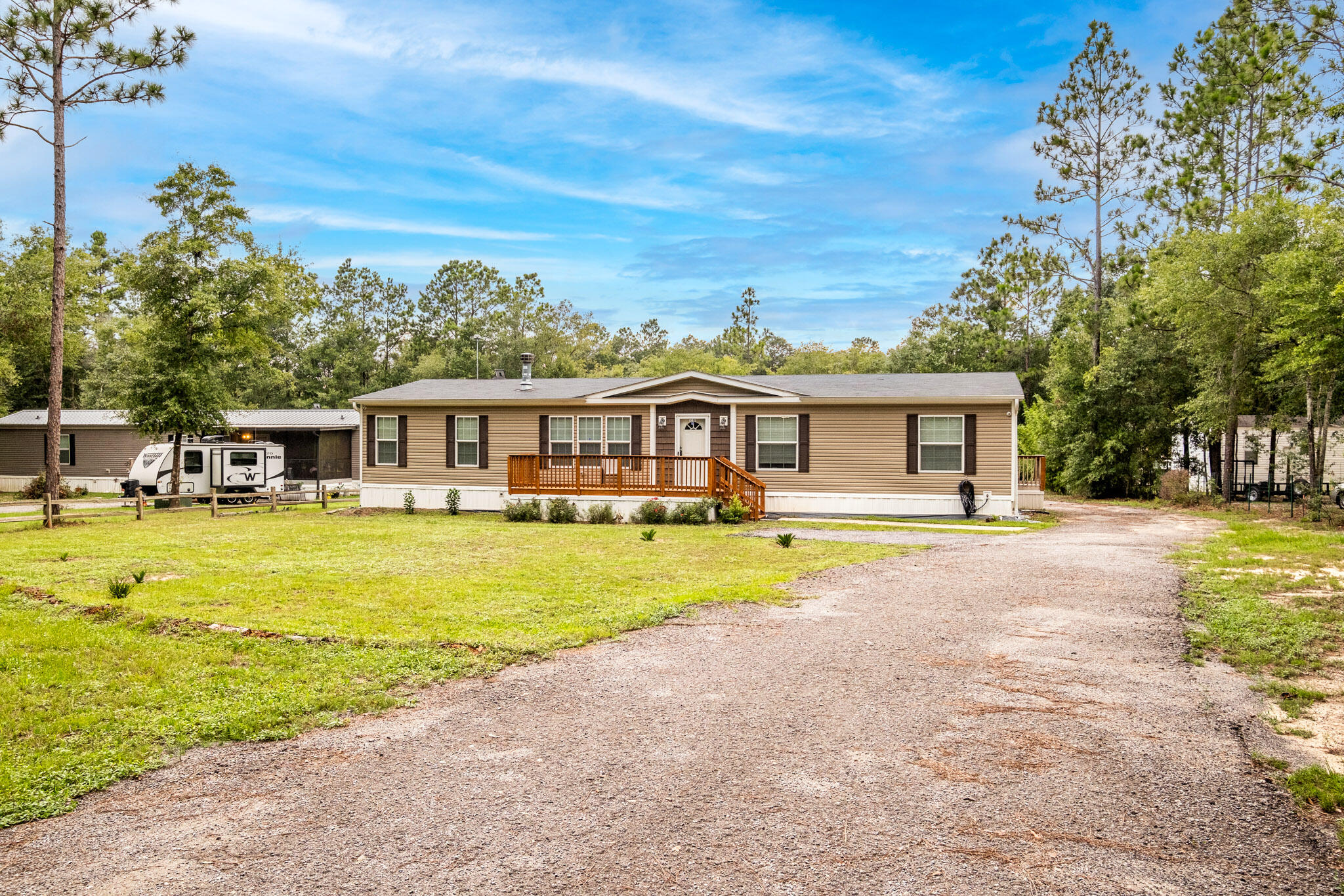 Move in Ready! Find your privacy at this 4 bedroom, 2 bathroom double wide home with a screened in porch that sits on a spacious .84 acre lot. Each bathroom features a garden tub for relaxation. This summer, cool off in the 20' above ground pool and when winter arrives, cozy up next to the fireplace. In addition to the main residence, this property features a detached 3-car garage with 120 & 240 electrical, RV hook up, Generator hook up, automatic doors and workshop.