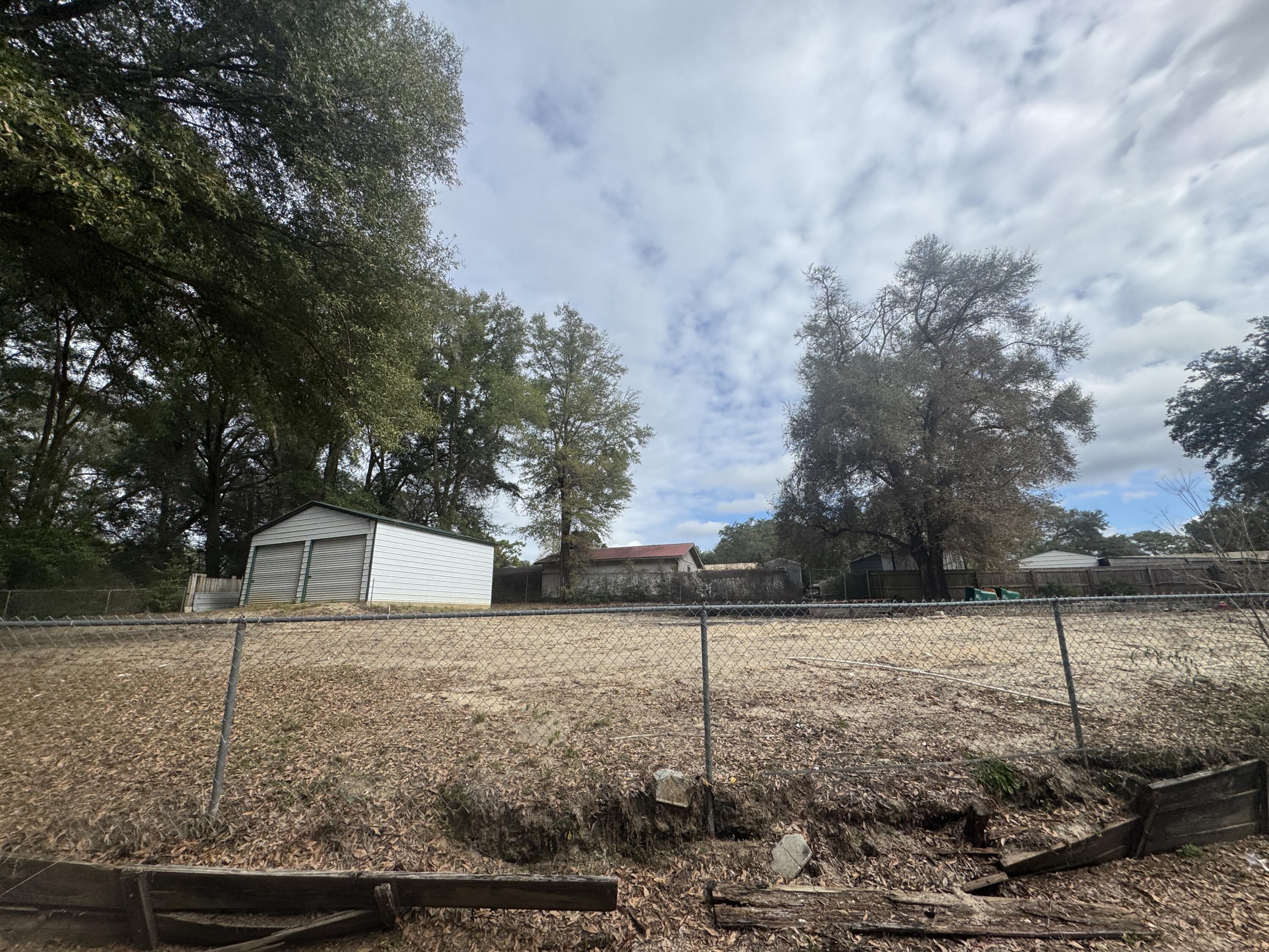 Opportunities like this don't come along often. Located in the center of Crestview, this .30-acre vacant lot is cleared, fully fenced, and ready for your next move—whether that's building a new home, placing a mobile home, or launching a home-based business.

The property previously housed a mobile home, which has been removed, leaving behind valuable infrastructure already in place. Utilities are available, the water tap fee has been paid, and a septic tank is on the property, saving you significant time and expense.

A standout feature is the 24x25 steel building on a concrete foundation, complete with two large roll-up doors and a standard walk-through door—ideal for a workshop, storage, or small business operation.

Mature trees provide shade and character, while the central  location puts you just minutes from Publix, Bob Sikes Airport, and Downtown Crestview. Just 30 minutes to Eglin AFB.

If you're looking for flexibility, functionality, and a location that truly delivers convenience, this property checks every box. Bring your plans and make it yours.