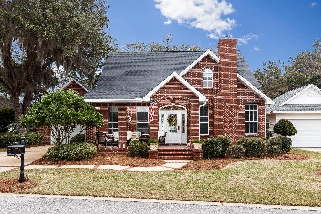 Carefree waterfront living in the charming community of Grand Oaks located on picturesque Boggy Bayou! This planned waterfront community nestled among gorgeous moss-laden oaks offers each homeowner a deeded waterfront parcel with a shared deep water dock! There is no need for flood insurance and you are only about 500' from your dock. This custom built, all brick home located on a low maintenance yard offers some water views from the front porch and living room. When you enter the home from the charming front porch you will find the bright living room featuring a gas fireplace, high ceilings and plenty of windows on the right. On the left is the formal dining room with wainscoting and crown molding that leads to the kitchen. The kitchen offers plenty of counter and cabinet space as well as a large pantry and a cozy breakfast nook. There are French doors in the breakfast nook that lead out to the large screened porch...the perfect place to enjoy your morning coffee! The downstairs master bedroom has a large walk in closet and roomy bath with a dual sink vanity, a whirlpool tub and separate shower. Up the back stairs, you will find a great bonus room...the perfect place for a home office! Up the front stairs are the two additional guest bedrooms that share the 2nd bath. These bedrooms have large closets AND storage in the dormers. This amazing home also features a 25KW full house generator, a 2009 Trane HVAC system, hardwood floors throughout the first floor, surround sound, central vacuum system, built in bookshelves and is MOVE IN READY. The dock that is only 500' away has electricity, water, a 1500lb lift and mooring poles for a boat slip (the perfect place for your sailboat!). Welcome home to a carefree waterfront lifestyle!