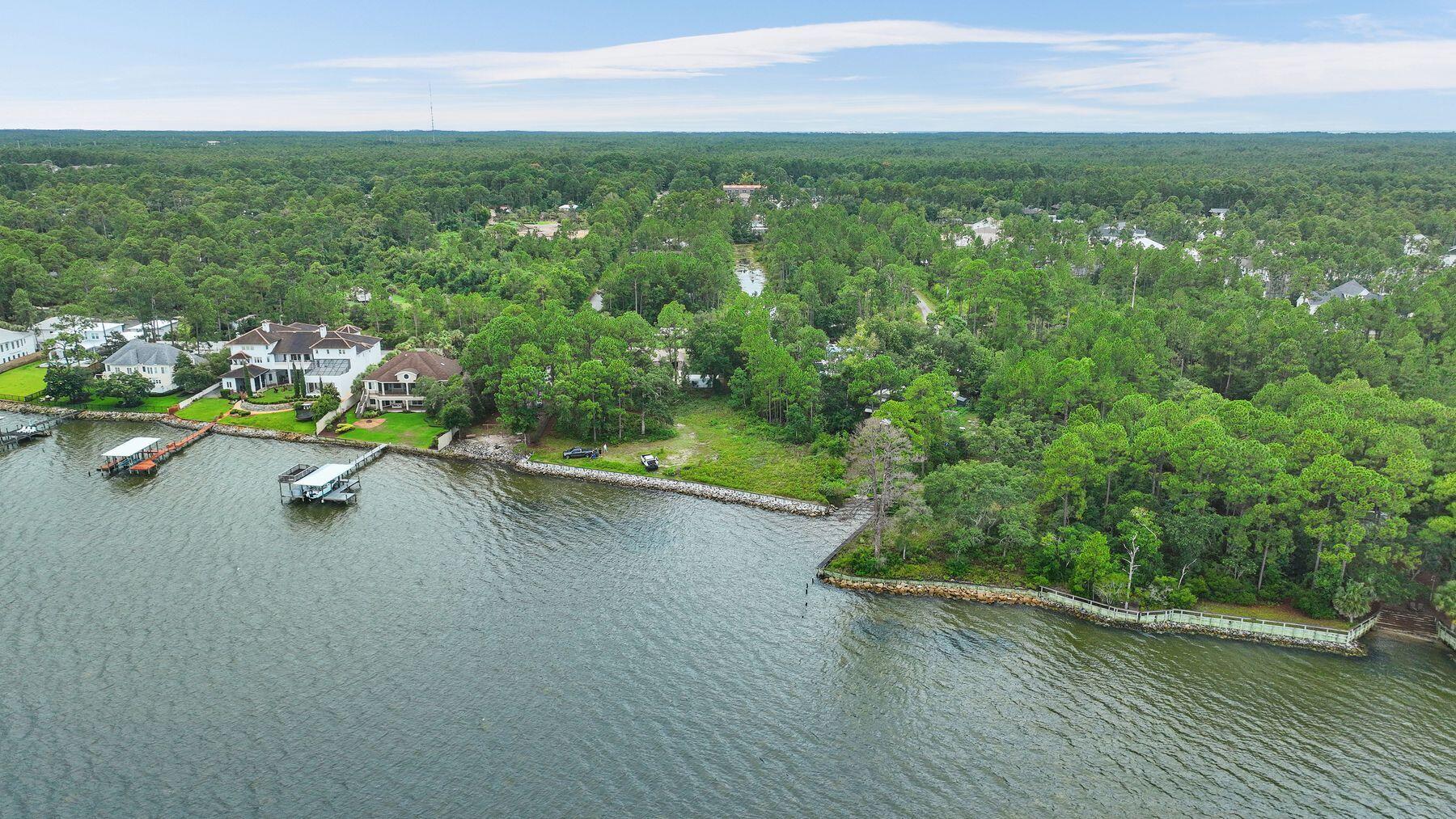 Rare opportunity to own 145 linear feet of Bay Frontage just west of 331 in a setting that has been crafted to create a beautiful estate compound.

A substantial single family lot can be used creatively to imagine a large estate home on one lot, and with the financed purchase of the adjacent lot one can complete an additional single family home or 'kids' house, pool and three car garage on the other.  With the opportunity to have two docks or two of everything, even one who wants to develop two fine homes should explore this setting.

With the purchase of this, the owner will finance the other lot for a limited time interest only so that you can preserve capital while you image your creations on this setting.  

Access easement of 20' in a flag orientation is provided in perpetuity.