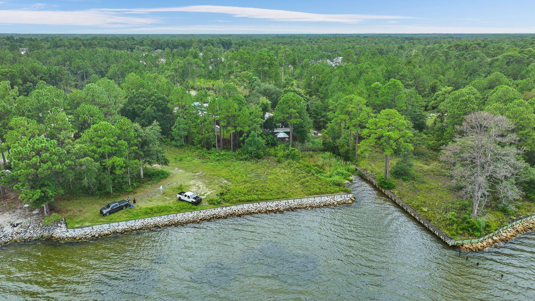 Rare opportunity to own 67 linear feet of Bay Frontage just west of 331 in a setting that has been crafted to create a beautiful estate compound.

A substantial single family lot can be used creatively to imagine a large estate home on one lot, and with the purchase of the adjacent lot one can complete an additional single family home or Family Compound. MLS 990441.  
With the opportunity to have two docks or two of everything, even one who wants to develop two fine homes should explore this setting.

With the purchase of MLS 990441 this lot can be financed interest only for 2 years at 5.25%.

This lot provides an access easement to the lot immediately east on the northern property line.