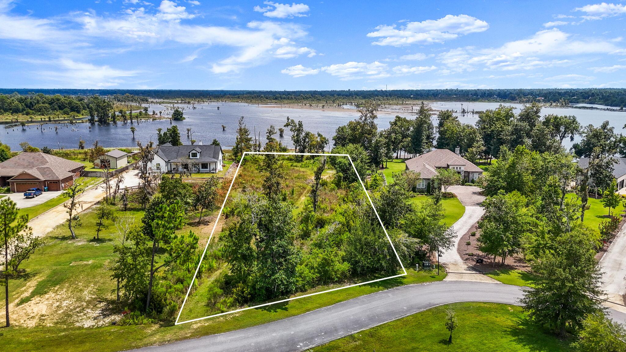 Discover this WATERFRONT opportunity to build your dream home on a 1.24-ACRE homesite in the stunning Cedar Creek community on Deer Point Lake. This expansive property with approximately 122' of water frontage offers an idyllic blend of beauty and seclusion in a community nestled within a serene wooded paradise. 

With approximately 122' of water frontage, this oversized property blends natural beauty, privacy, and convenience in a serene wooded community.

The homesite has incredible views and mature trees remain, creating a private, shaded retreat making it a blank canvas for your dream home. Wake up in the morning to coffee overlooking the waters of Deer Point Lake on your covered back porch. Enjoy the wildlife in your back yard from the comfort of your own home. Here, you'll have space for it all: your dream home, a pool, pole barn, detached garage, or storage for RVs, campers, and boats. With direct access to Deer Point Lake, you can enjoy fishing, kayaking, or simply watching the sunset from your own shoreline. 

Cedar Creek is a thoughtfully-designed, master planned community designed to preserve its natural charm while offering resort-style amenities. Residents enjoy a large community pool & clubhouse, playground & greenspace, golf cart-friendly streets and abundant wildlife in a peaceful, country-like setting. 

Known for its world-class fishing, Deer Point Lake is a haven for bream, bass, and shellcracker enthusiasts, while nearby Econfina Creek and the conveniences of Panama City dining, shopping, grocery stores, and more are just minutes away. 

This is more than land, it's an opportunity to create your waterfront legacy. Wake up each morning to sparkling lake views, spend afternoons on the water, and come home to a property tailored entirely to your lifestyle. 

Don't miss your chance to own one of the most desirable homesites in Cedar Creek. Eligible for 100% financing through USDA loan program.