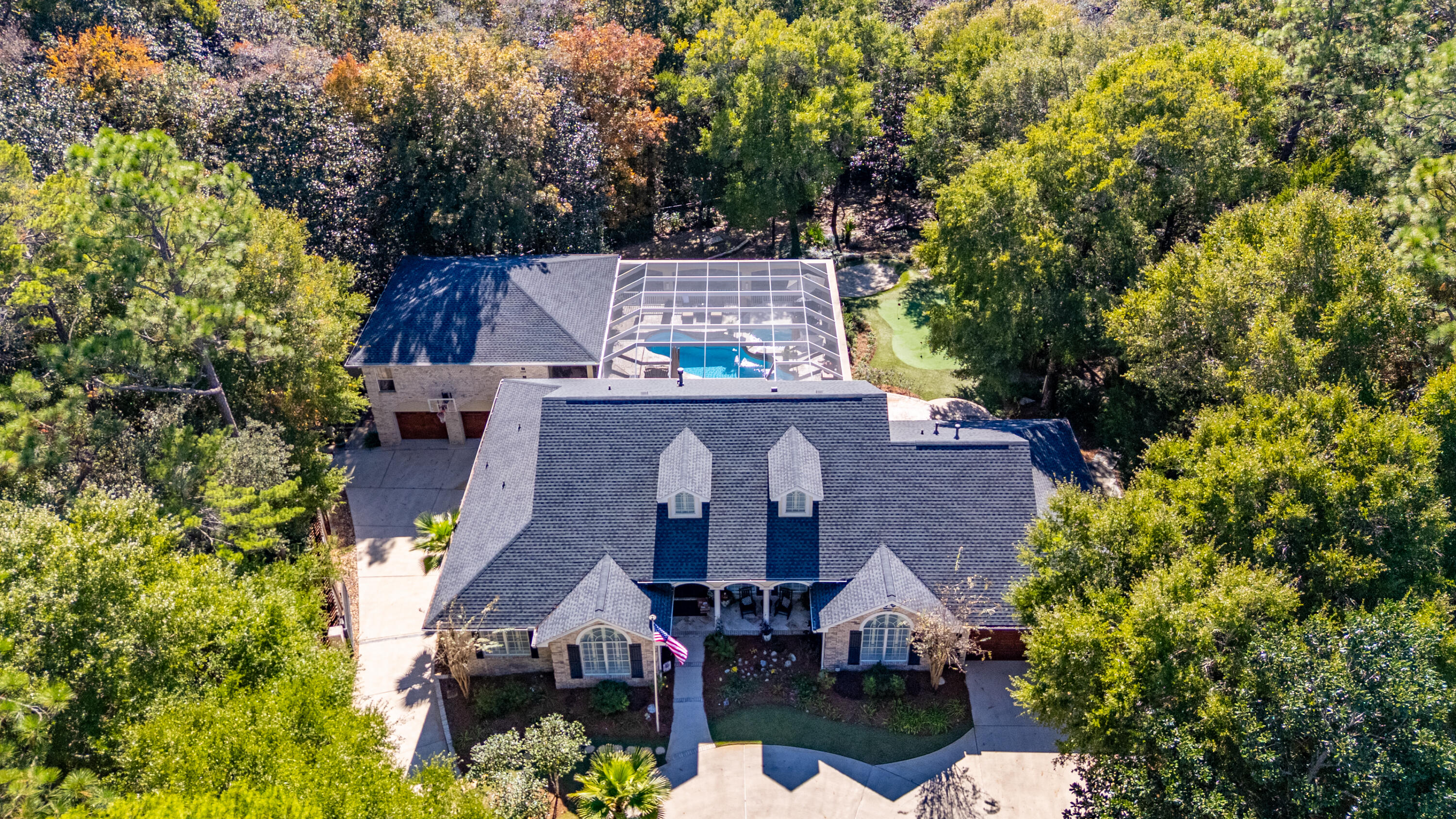 Nestled on over an acre of lush, tree-lined land in the sought after Rocky Bayou Country Club Estates, this exceptional residence offers more than 5,000 square feet of refined living space designed for comfort, privacy, and unforgettable entertaining. It's the kind of place where you can host a crowd—or hide from one.

Step inside to a brand-new custom kitchen featuring Taj Mahal quartzite countertops, solid cherry wood cabinetry, and double ovens. Whether you're whipping up a gourmet meal or just reheating last night's takeout, this kitchen makes it look good. The expansive layout includes five spacious bedrooms, six bathrooms, a grand office, and rich hardwood floors throughout the main living areas.

Now let's talk fun. Resort-style amenities include a screened-in heated saltwater pool and hot tub, a temperature-controlled wine room (it holds 1,200 bottles), a private sauna, home theater, game room, full bar, and even a personal putting green with a driving cage. Whether you're hosting a soirée or enjoying a quiet evening by the firepit, every corner of this home invites relaxation and celebration.

Car lovers, rejoice! Two separate attached garages offer six parking spaces, plus a driveway roomy enough for 16 cars. 

The fully fenced backyard backs up to a peaceful creek and is well lit for those magical Florida evenings. With mature trees, two outdoor sheds, and 2,400 sq ft of screened pool area, it's a private oasis with plenty of room to roam.

And when it's time to venture out? You're minutes from championship golf, top-rated schools, sugar-white beaches, and the best of Niceville and Destin.