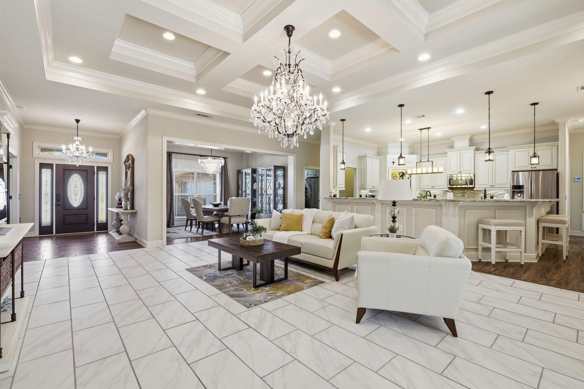 Located within a prestigious, thoughtfully planned neighborhood, this exceptional residence blends refined design with high-end upgrades and everyday functionality. From the moment you enter, the living room's coffered ceiling sets an elegant tone, complemented by high-end upgraded tile flooring that flows seamlessly throughout the home, creating a cohesive and sophisticated aesthetic.

The oversized three-car garage is a true showpiece, featuring full tile flooring, custom cabinetry, striking hexagon LED lighting, and a Mitsubishi mini-split system, offering a climate-controlled space ideal for a luxury workshop, gym, or additional storage. An expansive paver driveway enhances both curb appeal and convenience. Designed for elevated indoor-outdoor living, the enclosed lanai is anchored by a gas fireplace and dedicated gas line for grilling, creating the perfect setting for entertaining or unwinding year-round. The home also includes a tankless water heater, reclaimed water irrigation system for reduced utility costs, and hurricane window protection for added peace of mind.

An unfinished, insulated bonus room over the garage, already framed for a future bathroom or closet, offers endless possibilities for expansionideal for a private guest suite, home office, or media retreat. Residents also enjoy access to a low-cost, fenced storage area for boats, trailers, or RVs, a rare amenity in luxury communities.

The neighborhood itself is designed for connection and convenience, featuring sidewalks, underground utilities, and pedestrian access leading directly to the middle school. With a very easy commute to the military base, this home delivers both prestige and practicality in a highly sought-after setting.

Thoughtfully curated with upscale finishes, premium upgrades, and future flexibility, this residence offers an exceptional lifestyle in one of the area's most desirable communities.