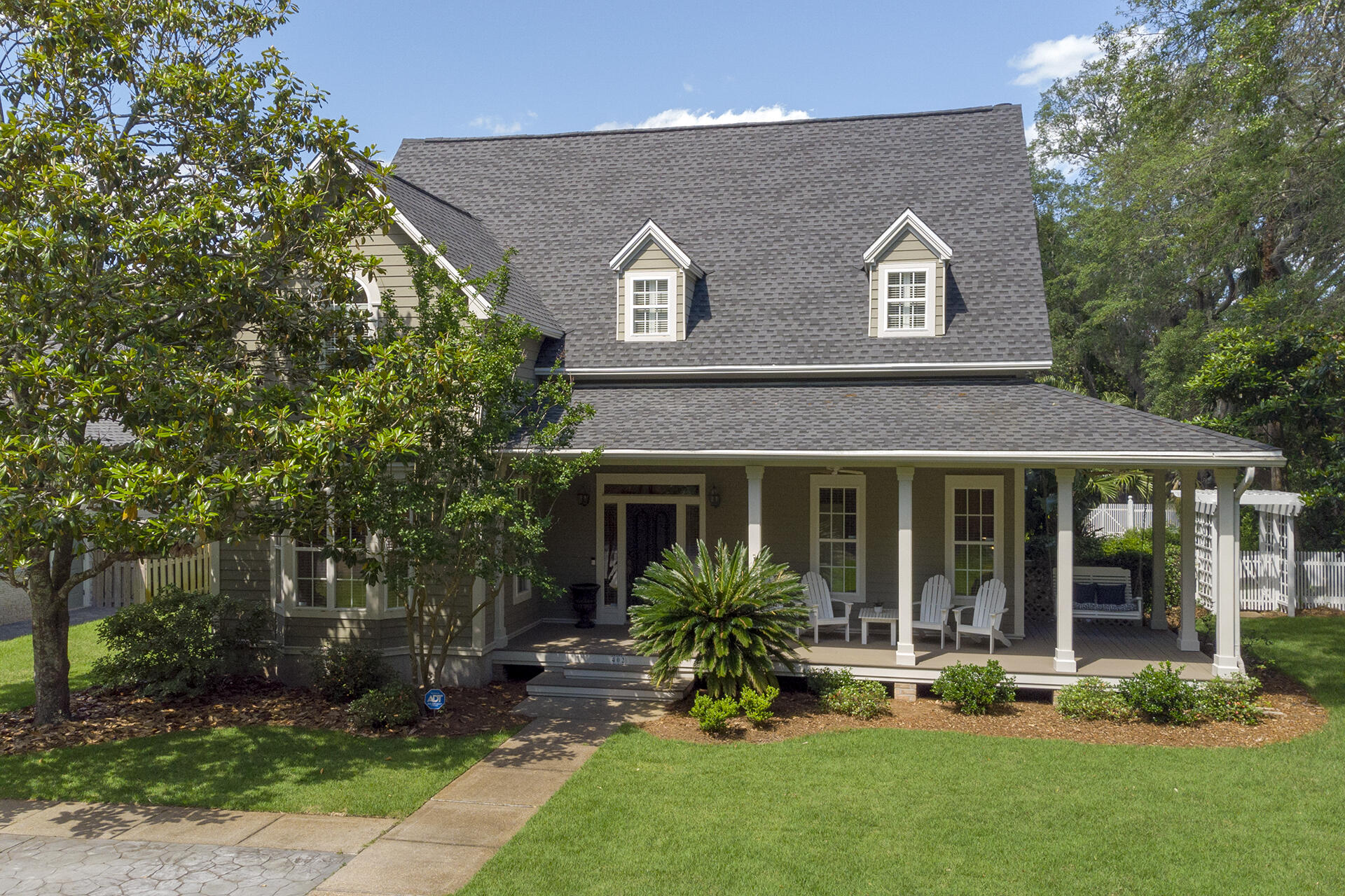 Gorgeous 4BR/4BA, 4055 SF custom home with lush landscaping and private pool. New roof, flooring, and kitchen remodel in 2021. Just a short drive from boat launch, parks, the harbor, and more. Entering this luxurious home, you are greeted with brick floors and a 30 ft tall foyer with a beautiful stairway. The first floor boasts the newly remodeled kitchen featuring stunning quartz counters with full backsplash, custom cabinets with amazing storage, spacious gourmet island, breakfast bar, five burner gas stove top, stainless steel appliances, wet bar, plantation shutters and a large dining area with bay window – perfect for entertaining guests. The living room features custom built-in cabinetry, fireplace, 100% waterproof LVP flooring, French doors leading to the covered patio and pool area. Also located on the first floor is a formal dining area, great room, bedroom with full bath and two large closets. The grand staircase leads to the second floor where there is a large Master suite with high ceiling, sitting area and huge his/her walk-in closet plus bonus walk in closet, his and her vanities, jetted tub, and separate shower. A Bedroom with walk in closet and private bath plus a spacious laundry room are also located upstairs. The loft above the garage has a 17 ft ceiling, full bath, and closet plumbed for kitchenette. The outdoor features include views of the bay, majestic live oaks, beautifully landscaped yard, with in ground Diamond Brite Onyx finished pool (plumbed for heater), jacuzzi, separate gated driveway and custom designed workshop. New A/C components in 2019 and whole house dehumidifier in 2020. Additional features include covered wrap around porch, oversized garage, two separate attics that are decked allowing for large amounts of storage space, custom interior, and exterior lighting, and private well for irrigation.