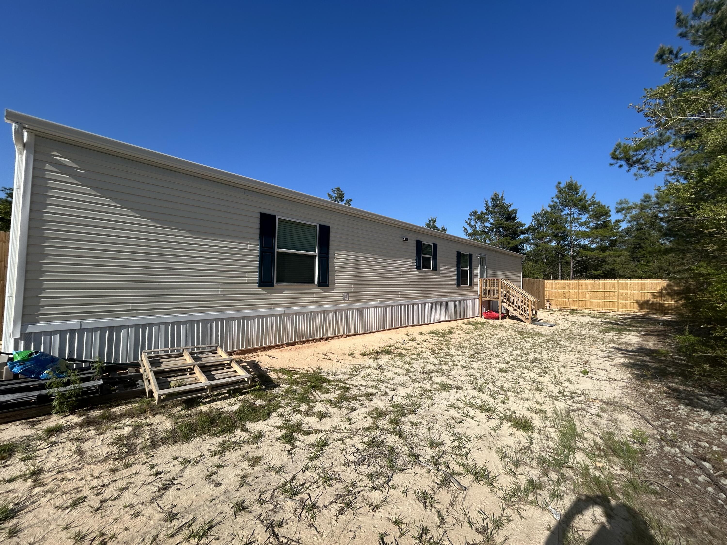 Now available for lease—18 Daffodil Circle! This brand new 2024 manufactured home offers 3 bedrooms, 2 bathrooms, and just under 1,200 square feet of thoughtfully designed living space. The split floor plan provides privacy, while the open-concept layout creates a warm and inviting atmosphere. Enjoy a spacious living area, a modern kitchen, a private primary suite with an en-suite bathroom, and a tucked-away utility room for added convenience. With energy-efficient features and stylish finishes throughout, this home is move-in ready and perfectly situated in a quiet, convenient location. Don't miss your chance to call this beautiful home yours—schedule your showing today!