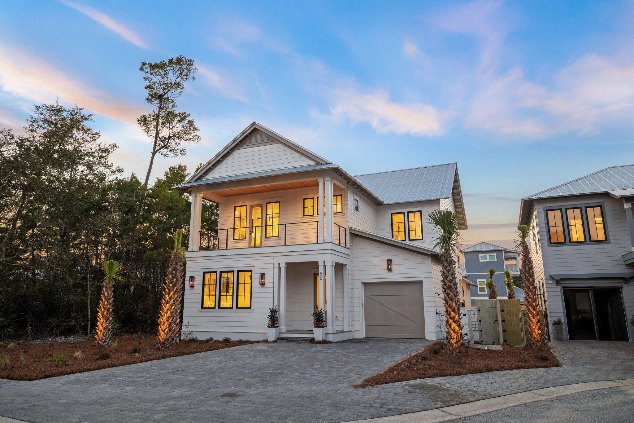 Discover coastal elegance in the prestigious Lakeside community of Inlet Beach at 85 Pine Cone Trail. This newly constructed residence by Focus Construction epitomizes luxury with high-end finishes and meticulously designed spaces. Step through the doors to find a home where comfort meets sophistication. High ceilings and abundant windows in the living areas forge a bright and airy atmosphere, accentuated by the rich tones of cypress wood ceilings and premium hardwood flooring.

The state-of-the-art kitchen will thrill any culinary enthusiast with its Thermador appliances, bespoke cabinetry, and chic black hardware. Perfect for hosting, the home features an exquisite pool cabana complete with a BBQ grill, a cozy fireplace, a television, a wine fridge, and an ice maker—ideal for